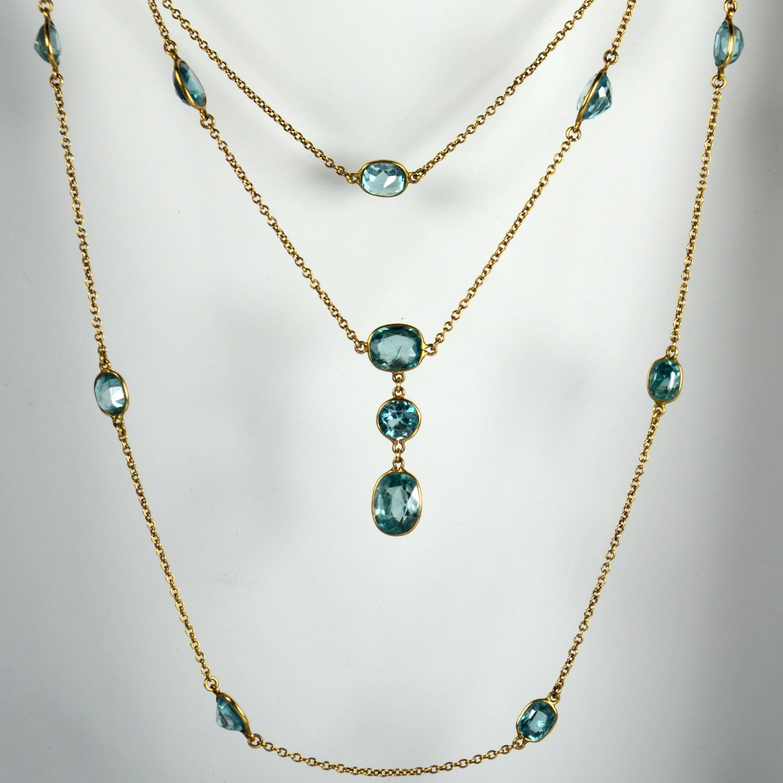 A fabulously long chain necklace in unmarked 14 carat gold set with 23 oval and round-cut blue zircons. The zircons are spectacle-set to the chain and are estimated to weigh approximately 43 carats in total.

This wonderful piece measures 108cm in