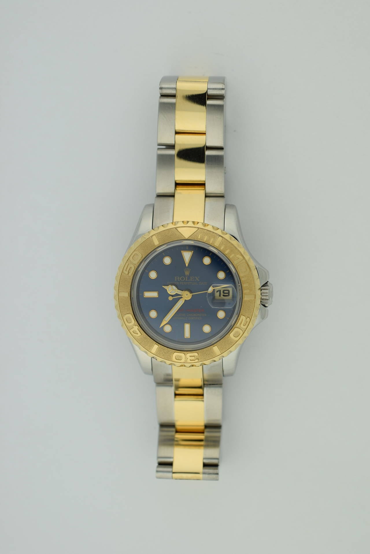 Rolex lady's stainless steel and 18K yellow gold Yachtmaster. Blue dial. 
Automatic movement. Two tone 18K yellow gold bezel and stainless steel case. Bezel rotates. Circa 1996-1997  Serial number T-6341xx . Calendar date. Case diameter