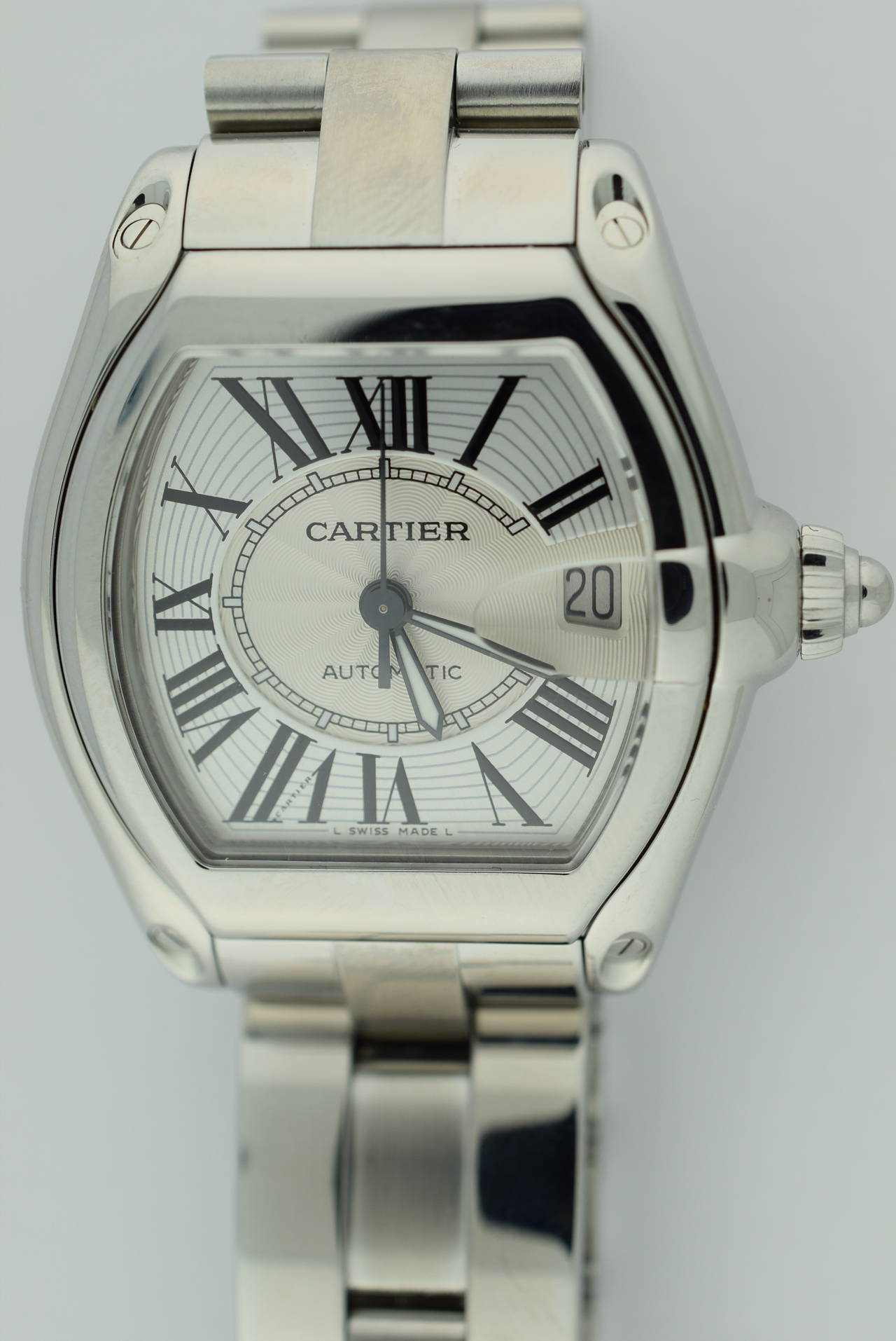 Cartier automatic men's Roadster in stainless steel case and band. 38.5mm diameter size. Case thickness 12mm. Band width 19mm. Band is fully linked. Comes with original box and Cartier instruction manuals. Circa 2007-2010. Roman numeral dial with