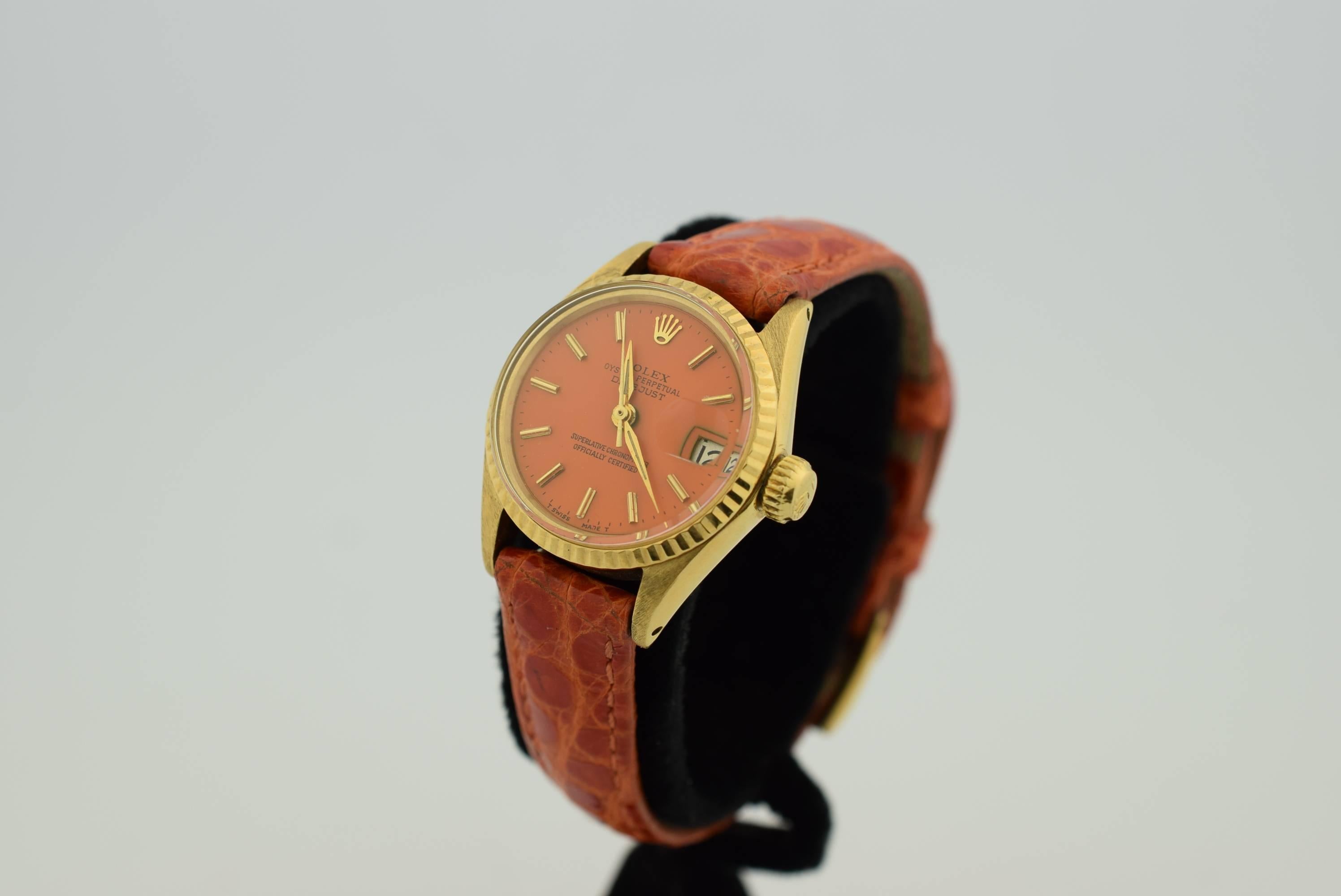 Rolex Ladys Oyster Perpetual  Datejust .18K Yellow Gold .President Head .
Circa :1960. Automatic movement .Refreshed Orange Dial with Gold Hour markers .Orange Crocodile Strap with Gold Plaque Rolex Buckle .Serial numbers :1329xxx.Comes with Rolex