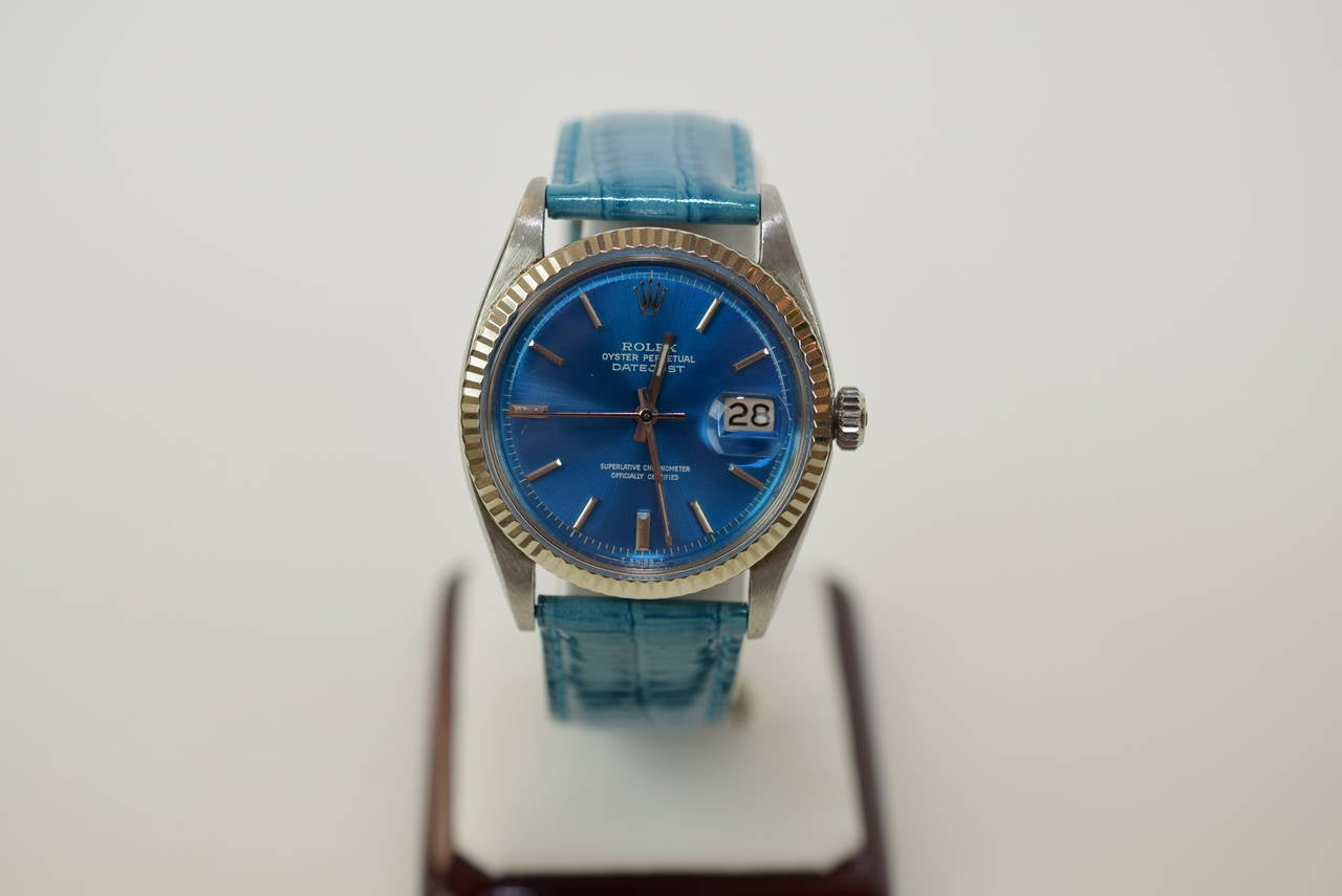 Rolex Datejust stainless steel case with a 18K white gold bezel.  Circa 1966. Reference 1601. Comes with a blue retouched dial. Blue alligator band. Automatic movement. 

All of our watches are guaranteed and warrantied for one year from date of