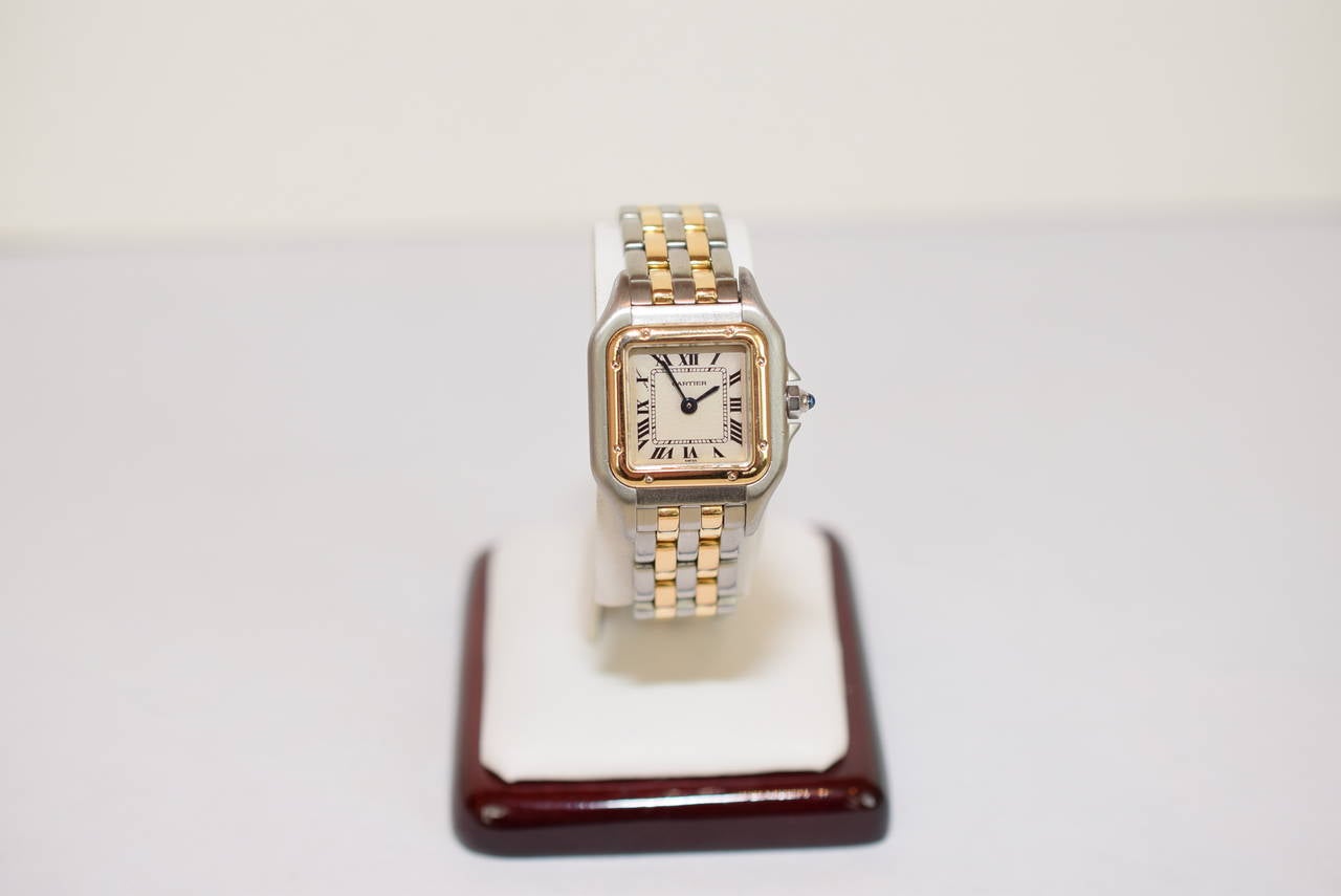 Cartier two tone lady's Panther wristwatch. Two rows of gold in band. Made in Switzerland. Quartz movement. Good condition. Cartier two tone deployant style buckle. Reference 112000R. Comes with Cartier Box. Dimensions :25mm x 32 mm .