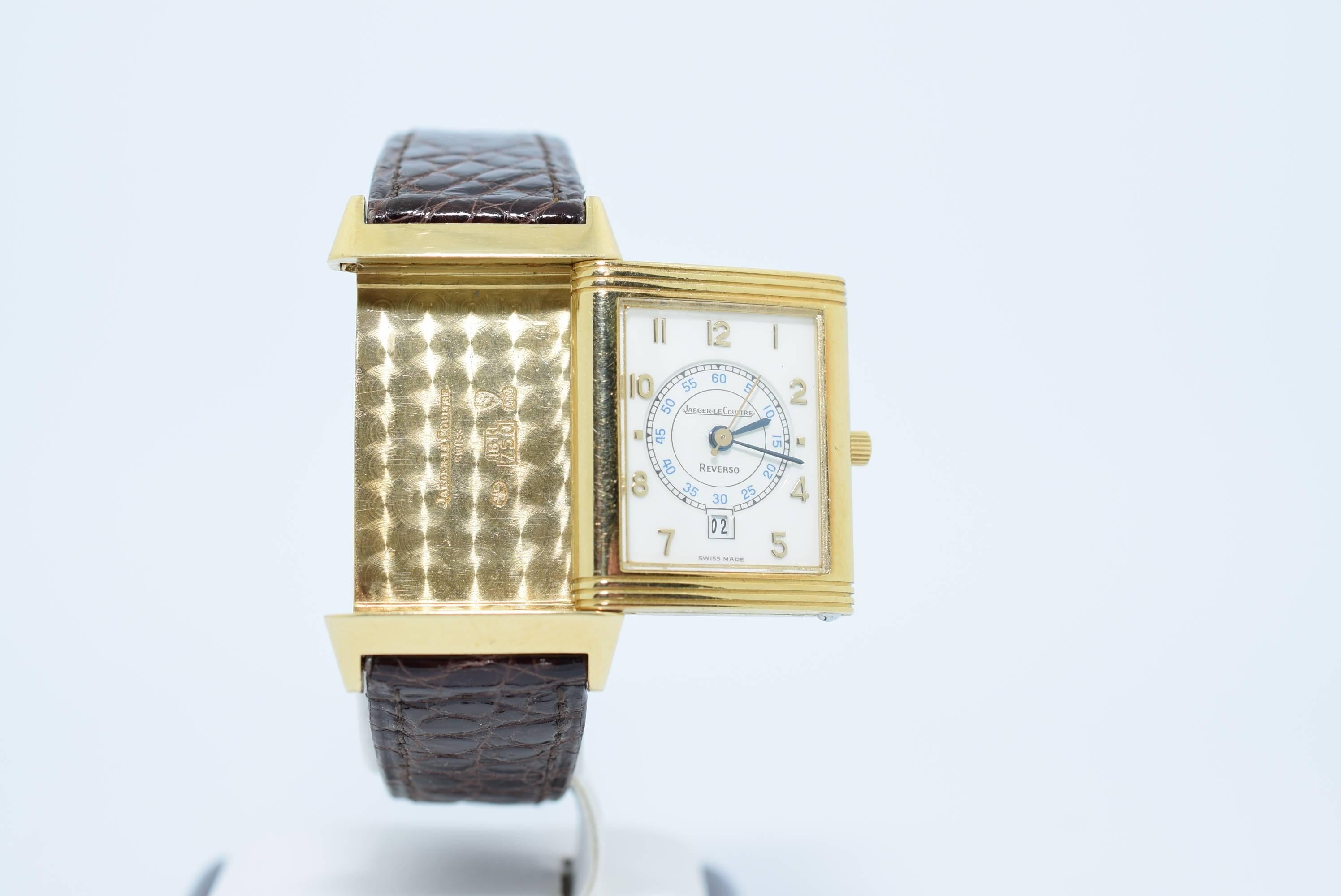 Jaeger Le Coultre ladies Reverso watch in 18k yellow gold, quartz with calendar.
Model number - 250.1.11
Circa 2005
White Enamel Dial with arabic numerals.
Dimensions: 1.75x1.0 inches
Brown Crocodile Band
Serial number _ 1671614
Warranty for