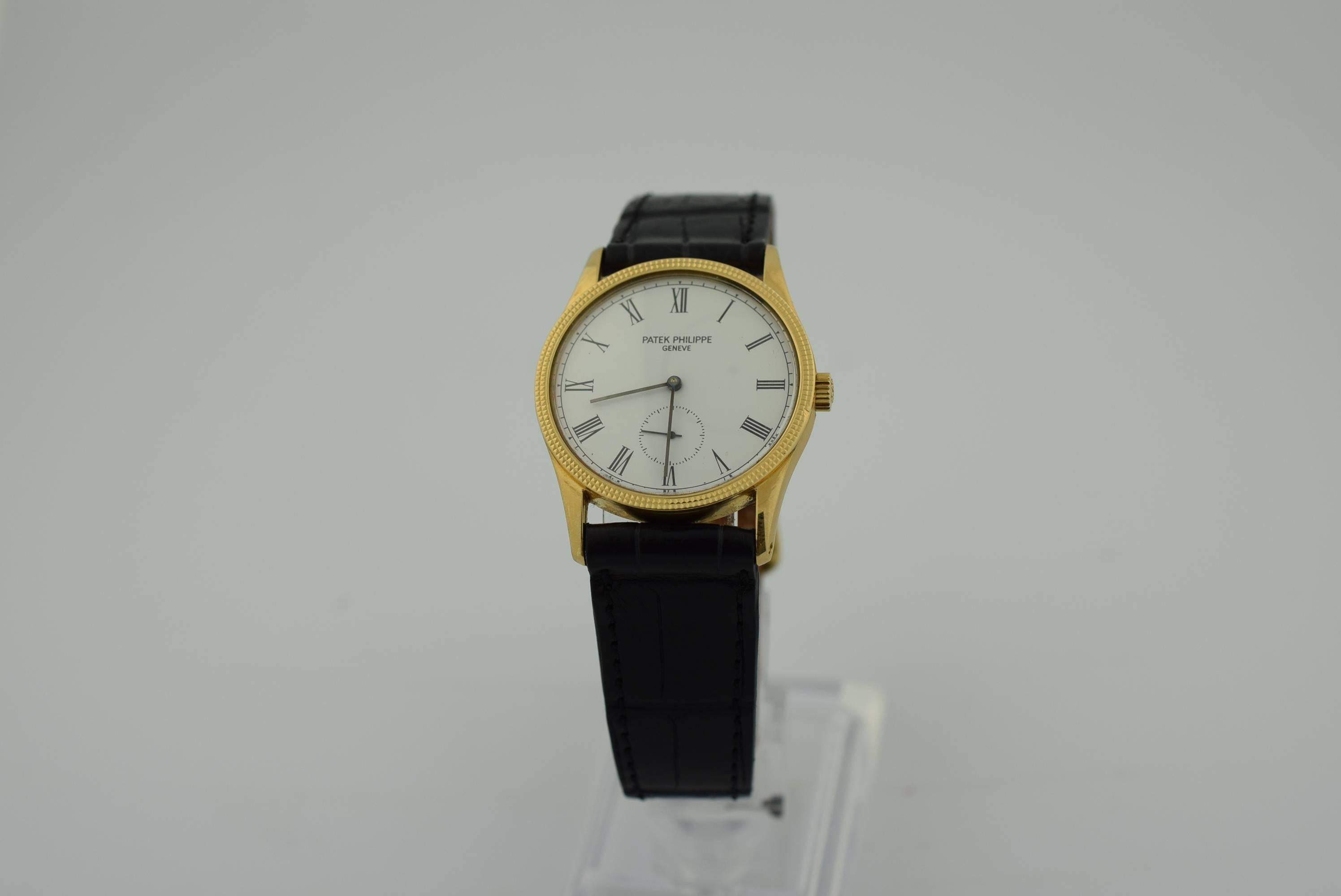 Patek Philippe 18k Yellow Gold Calatrava model 3796 J .
Manual wind .White Dial with Roman numerals . Sub second hand .
33 mm case diameter .Patek snow flake crown .Hob nail bezel .Black crocodile band .Excellent condition and recently serviced