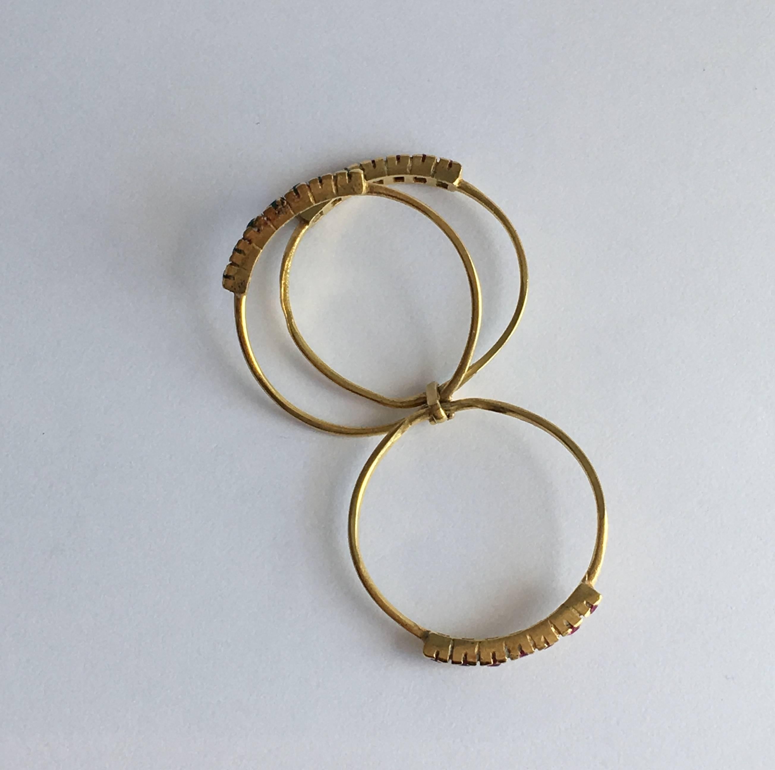 The ruby is considered the queen of gemstones, inspiring power and love, while emeralds are thought to promote balance and harmony. The two stones are stylishly paired in this delicate and colourful 18ct gold ring. The multi-band style is based on