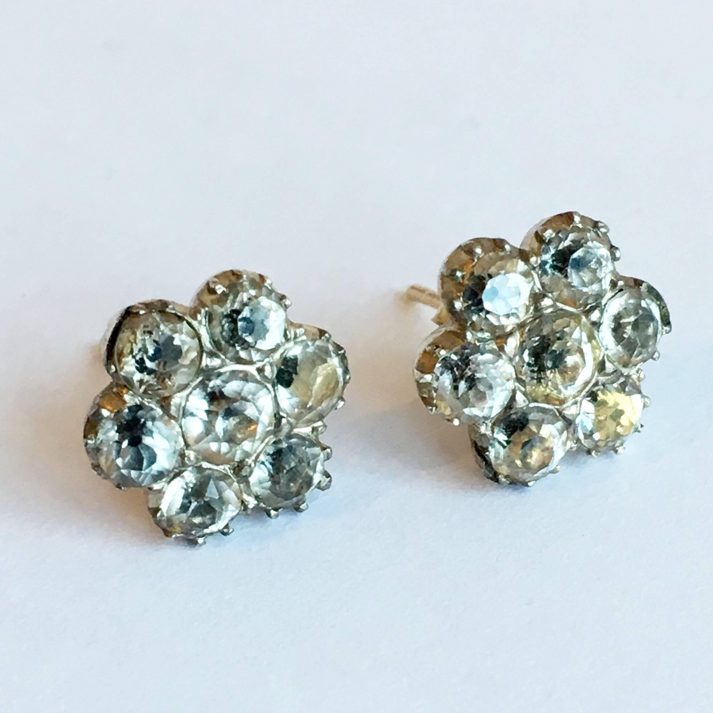 In the Georgian era, paste was virtually interchangeable with diamonds and often set in precious metals such as gold and silver. With their distinctive black dot culets, these dainty flowers are a lovely example. Pinched collet silver settings