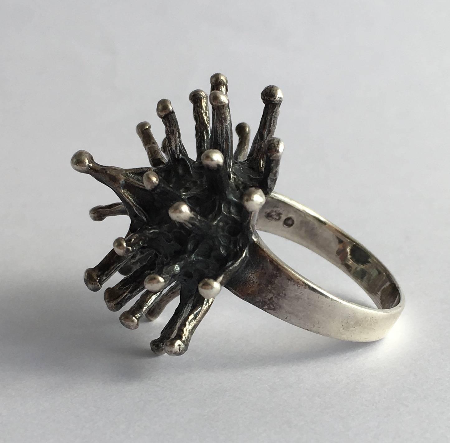 The starburst design of this stylish ring has a dynamic energy reminiscent of the solar system. The size alone makes a statement while the modernist design has a cool, edgy feel. It is sterling silver with polished tips and an oxidised body. 
