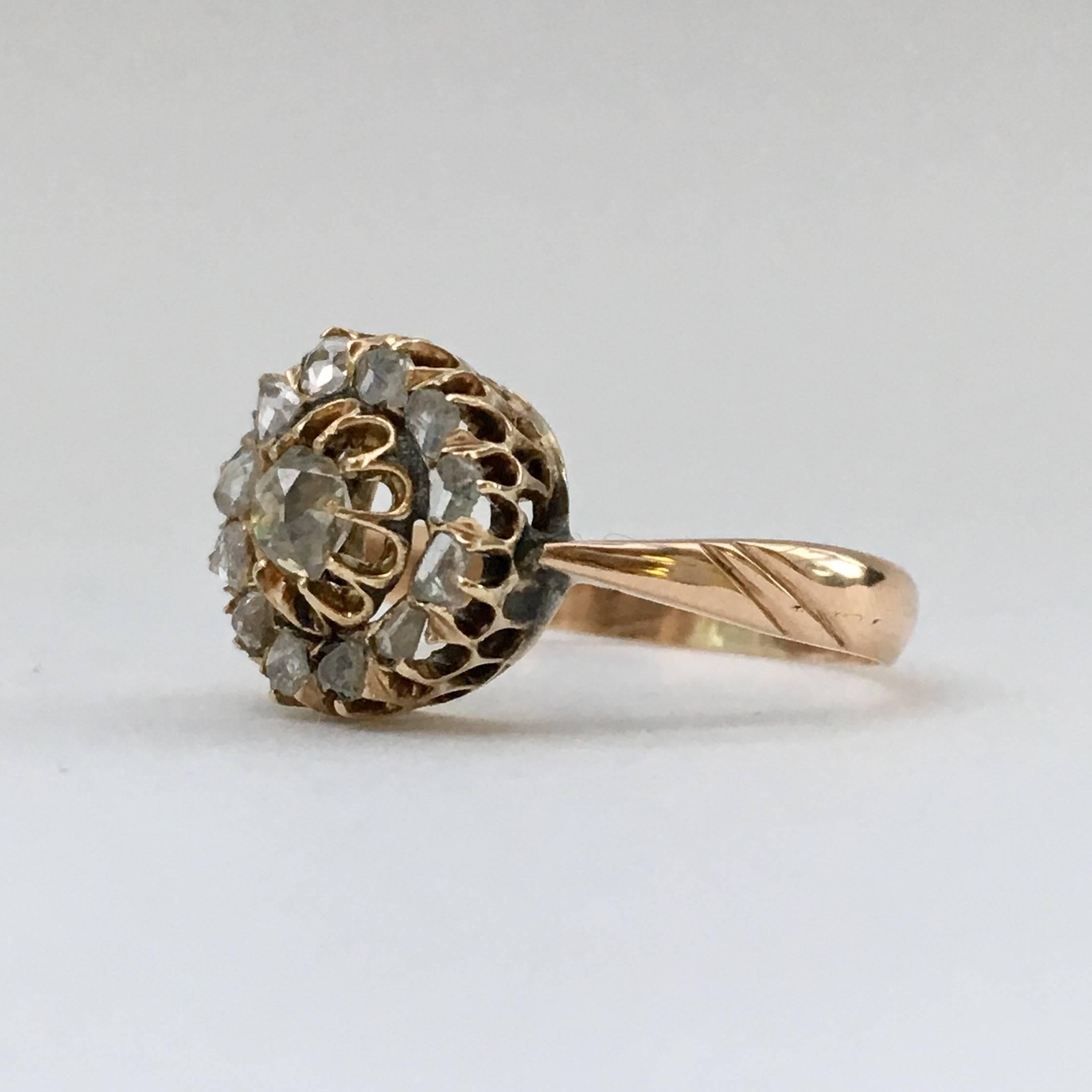 This beautiful Russian antique diamond ring may have started life as one half of a pair of earrings and later been converted into a ring. The central stone is a lovely cushion cut diamond, which sparkles beautifully. It is surrounded by rose cut