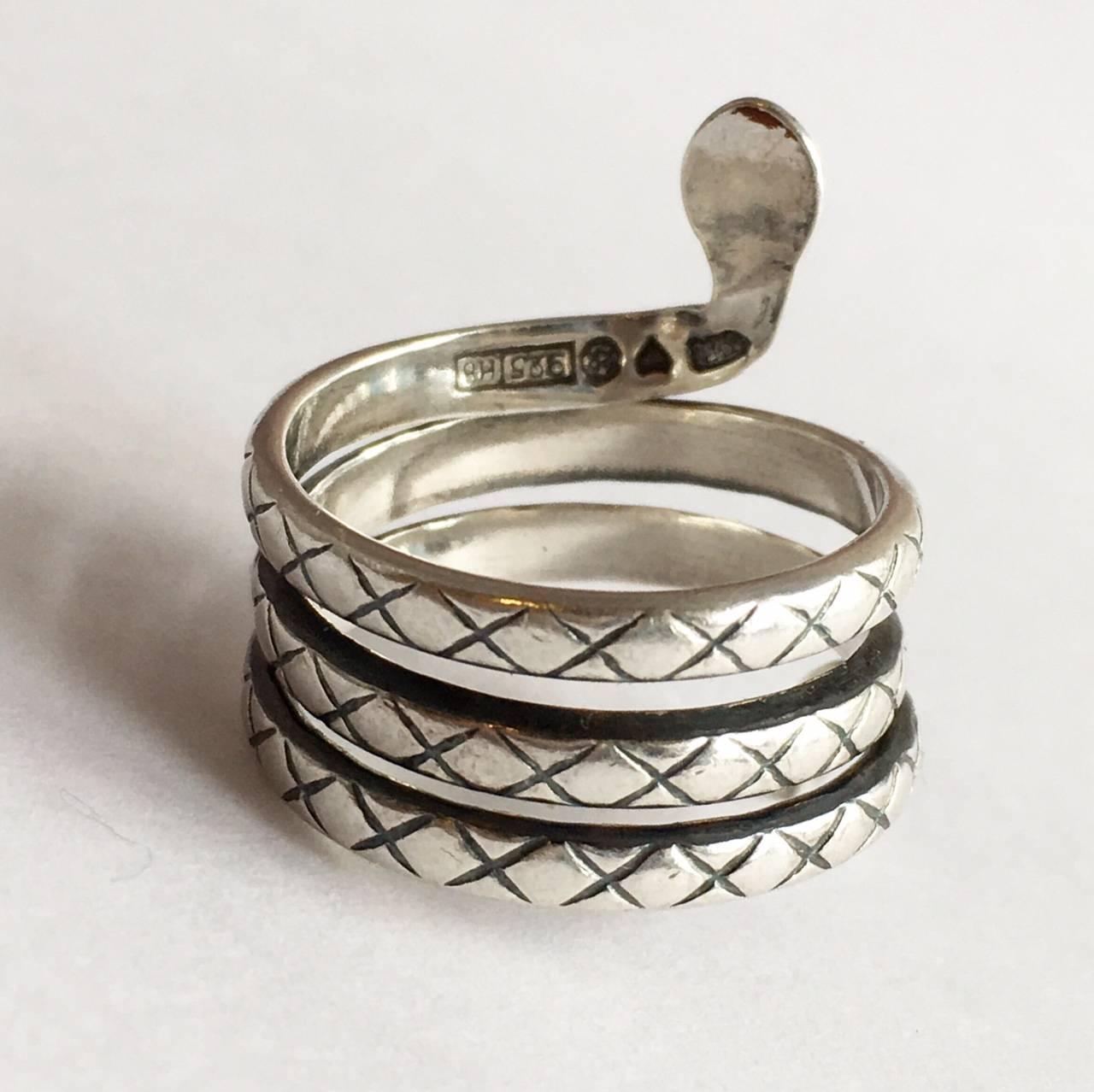 Designed by Finnish designer Kalevala Koru, this sterling silver snake ring coils around the finger appealingly. The crisscross etching and little eyes are nicely done, giving the little fellow an affable air.  

Snakes are revered in many cultures