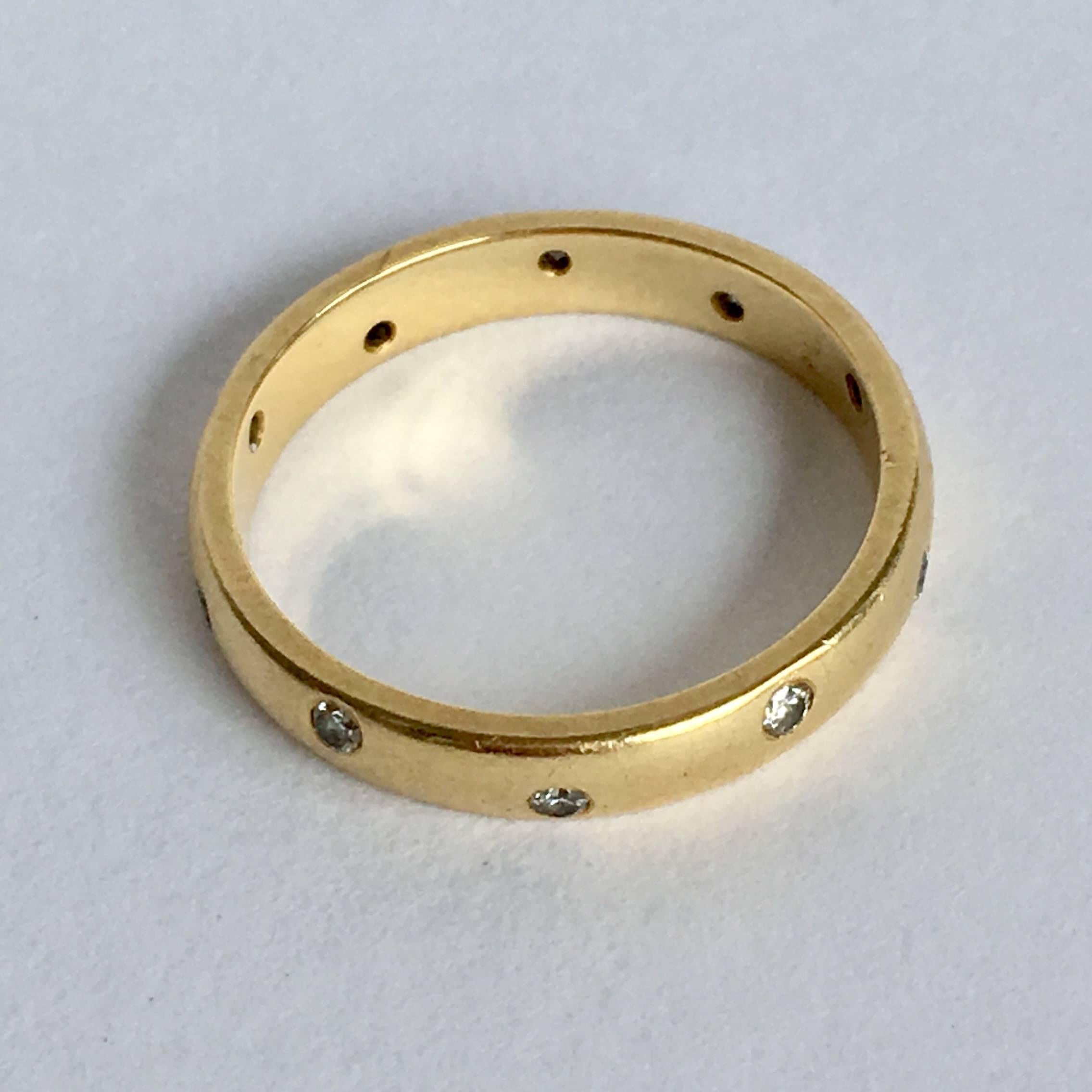 The brilliant cut diamonds of this simple 18ct gold band ring twinkle like stars. Stylishly understated, this ring bridges the gap between a plain gold band and an eternity ring. It looks lovely worn on its own but also makes the perfect stacker.