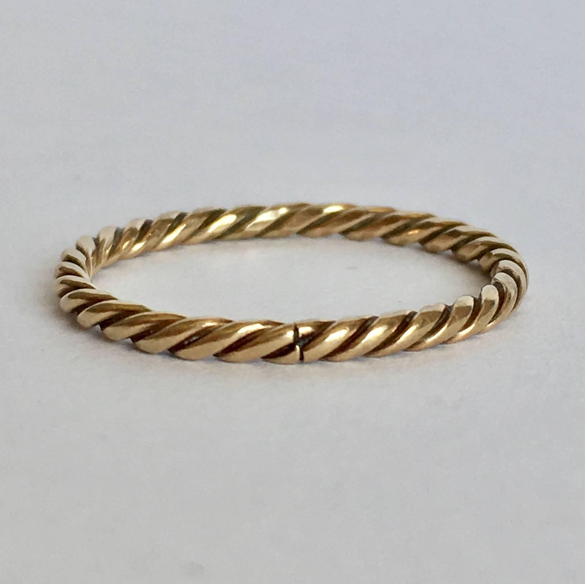 A simple twisted 9ct gold band, this ring is beautifully elegant. Worn alone, it looks understated and cool. Alternatively, it makes the perfect stacking band to layer up with other favourites - or, it could be attached to a chain and used as a