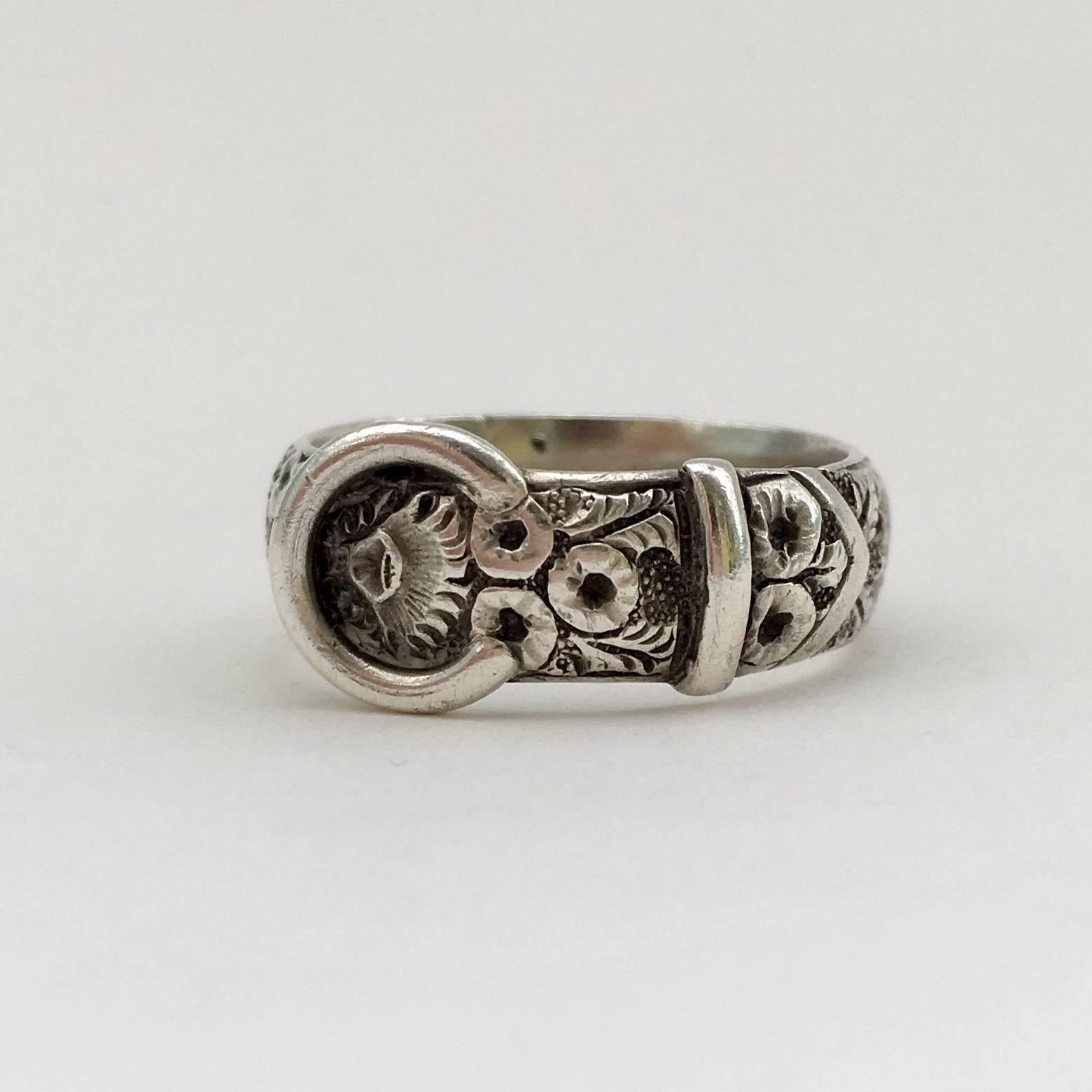 This beautiful engraved ring dates from 1882. It is a lovely example of a buckle ring from the Arts and Crafts period. It has a nice weight, making it pleasingly tactile, and is engraved with a charming floral design. 

Size: UK O, US 7