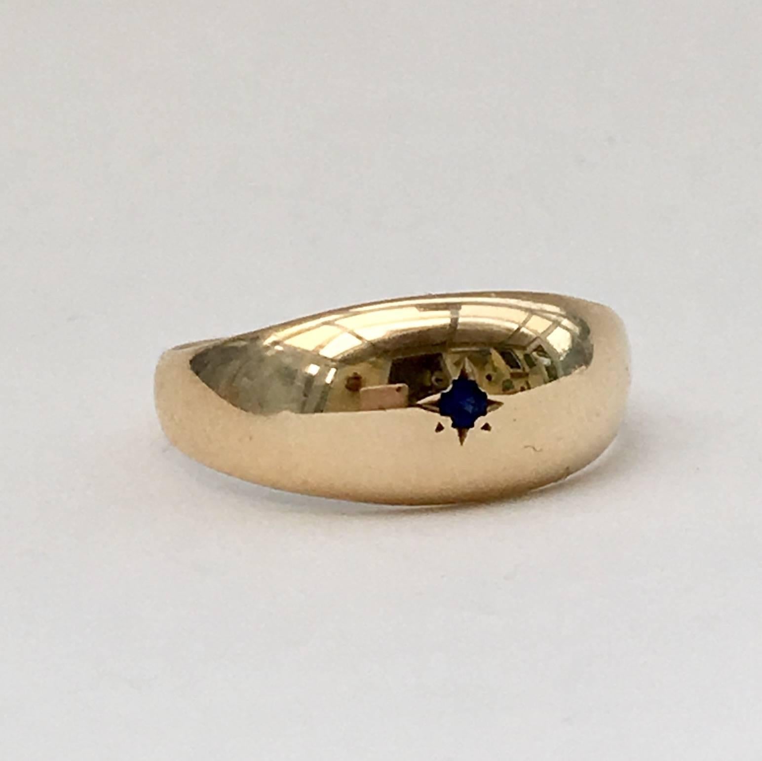 This stylish 9ct gold ring dates from 1969. It has a tiny midnight blue sapphire, set inside a four-point star. The design is beautifully understated and oozes with contemporary appeal.  

Size: UK N 1/2, US 7