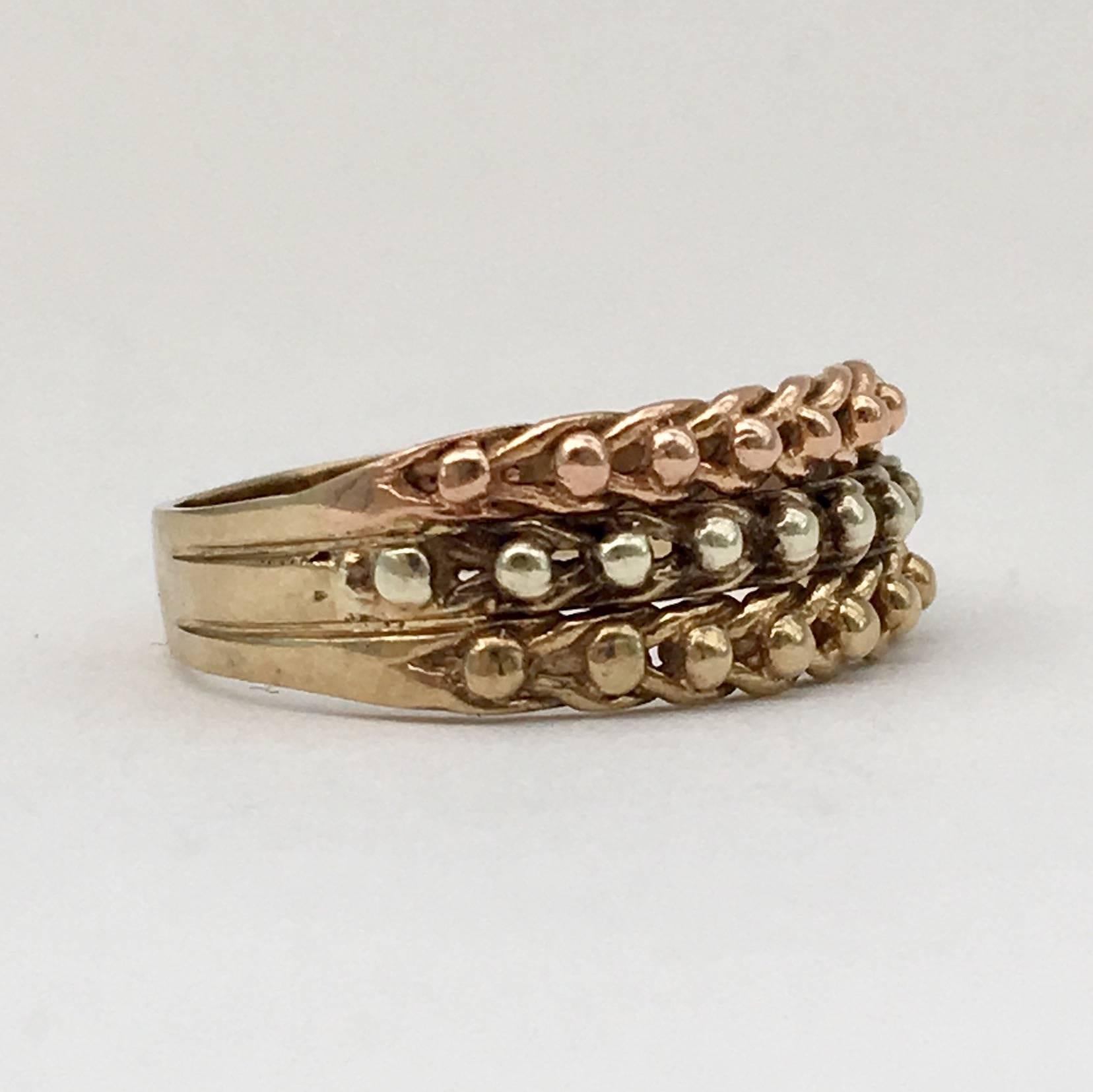 The ‘keeper’ ring or ‘guard’ ring was originally a simple band worn above a more valuable ring to prevent it sliding off the finger. Over the years, they became more elaborate in design. This is a lovely example, combining pretty braids of yellow,