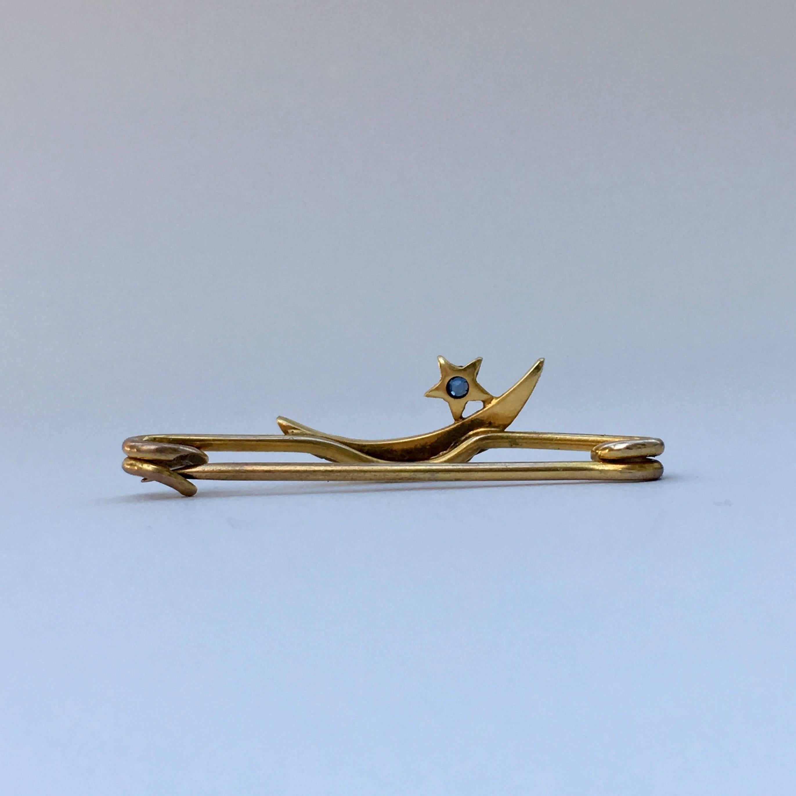 This dainty 9ct gold bar brooch combines seed pearls with a tiny sapphire, perfectly reflecting the night sky. The condition is remarkable for such a delicate piece and the celestial theme is particularly on trend at the moment. 

Total length: 3cm
