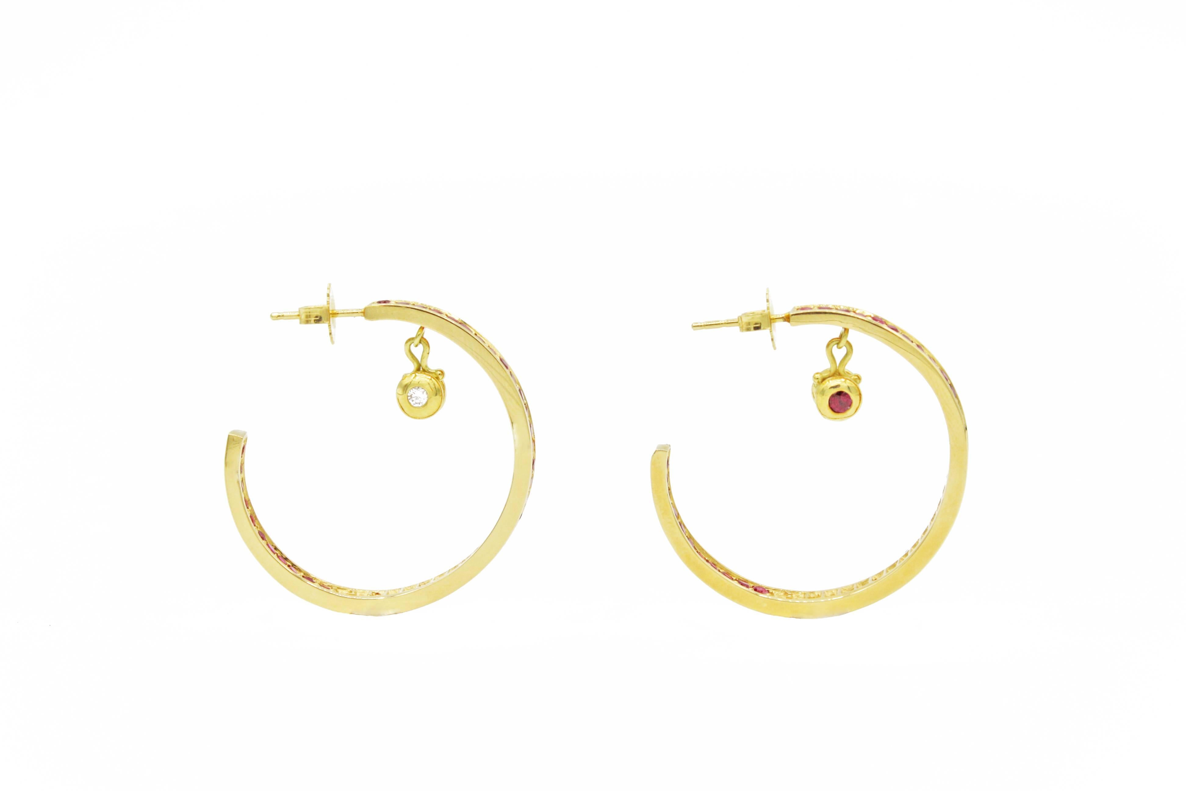 These unique 18kt gold hoop earrings have 3.50 cts rubies set along the outside and a portion of the inside of the hoops.  The gold droplets within the hoops are also set with 0.17 cts rubies on one side and 0.15 cts diamonds on the other side,