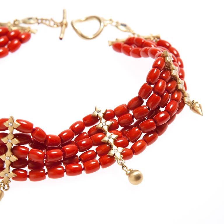 This one of a kind Renato Cipullo choker in the Etruscan Roman style is made
of Mediterranean coral and has five 18kt gold spacers each with four diamonds  and a gold drop.  The exquisite clasp has two square sapphires and two rubies.
Total length