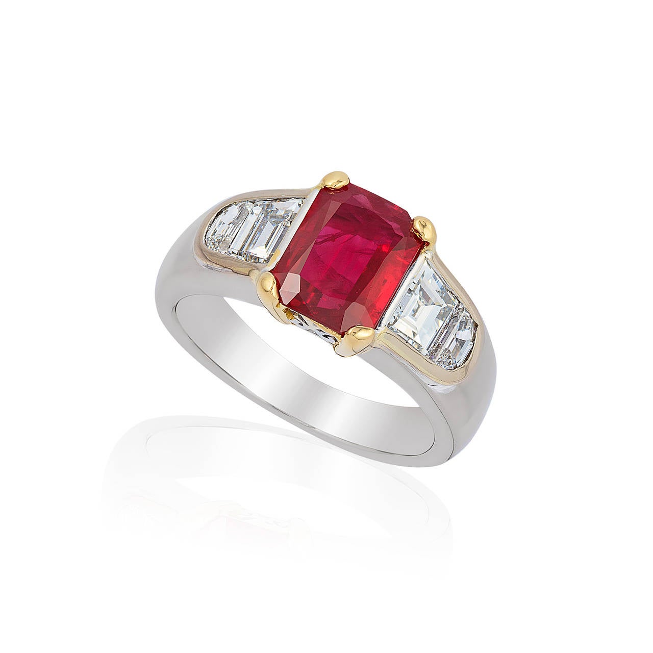 Exceptional Ruby and Diamond ring set in 18k White and Yellow gold
Size 4 3/4
Ruby 2 carats octagonal GIA certified
2 trapezoid diamonds .85cts color F quality VS
2 half moon diamonds .35cts color F quality VS