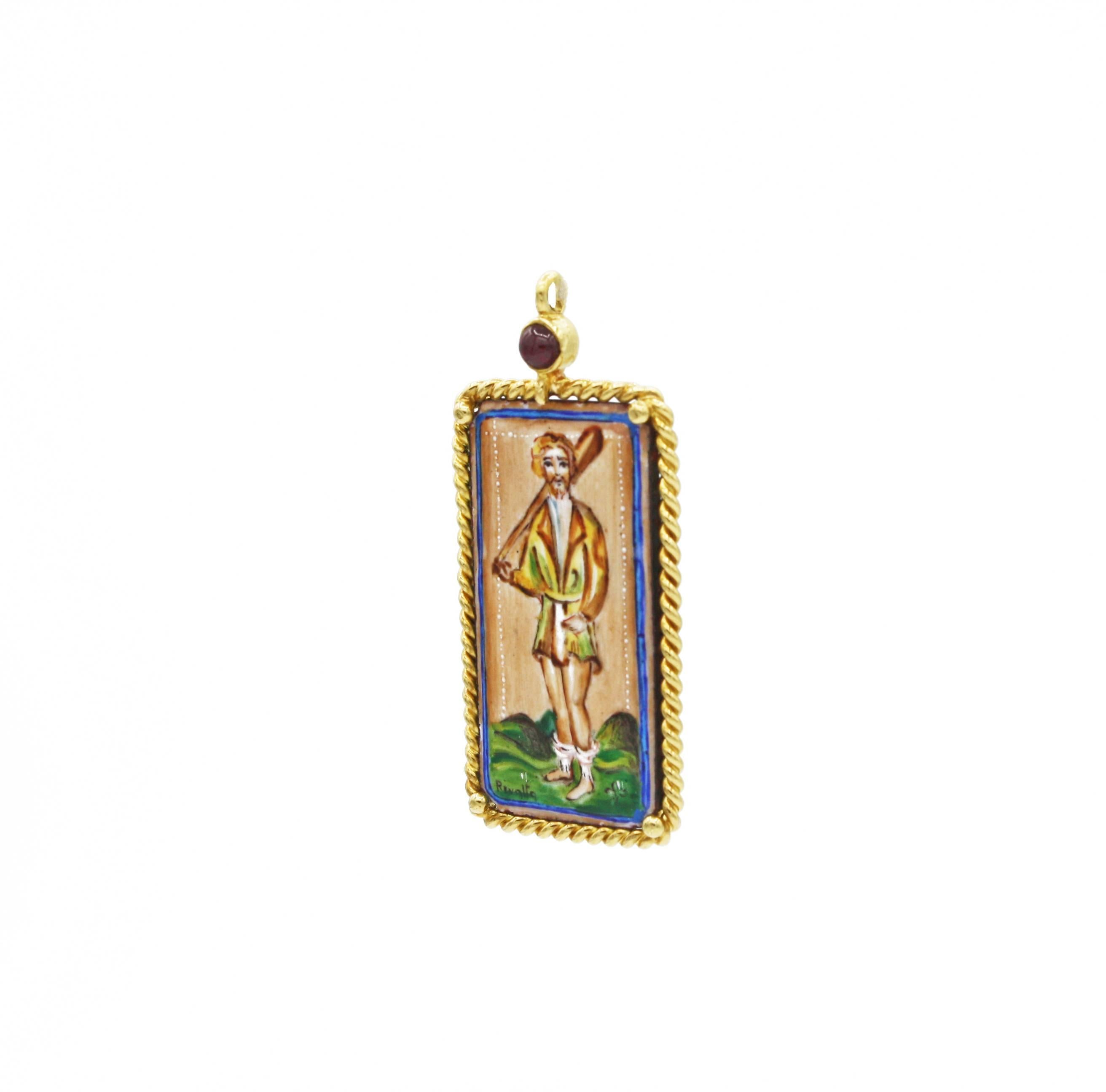This rare, hand-painted enamel tarot card pendant is set in an 18kt gold frame with rope detailing.  Adding to its special qualities, there is a round cut ruby set into the top of the pendant. The tarot card pictured is the 