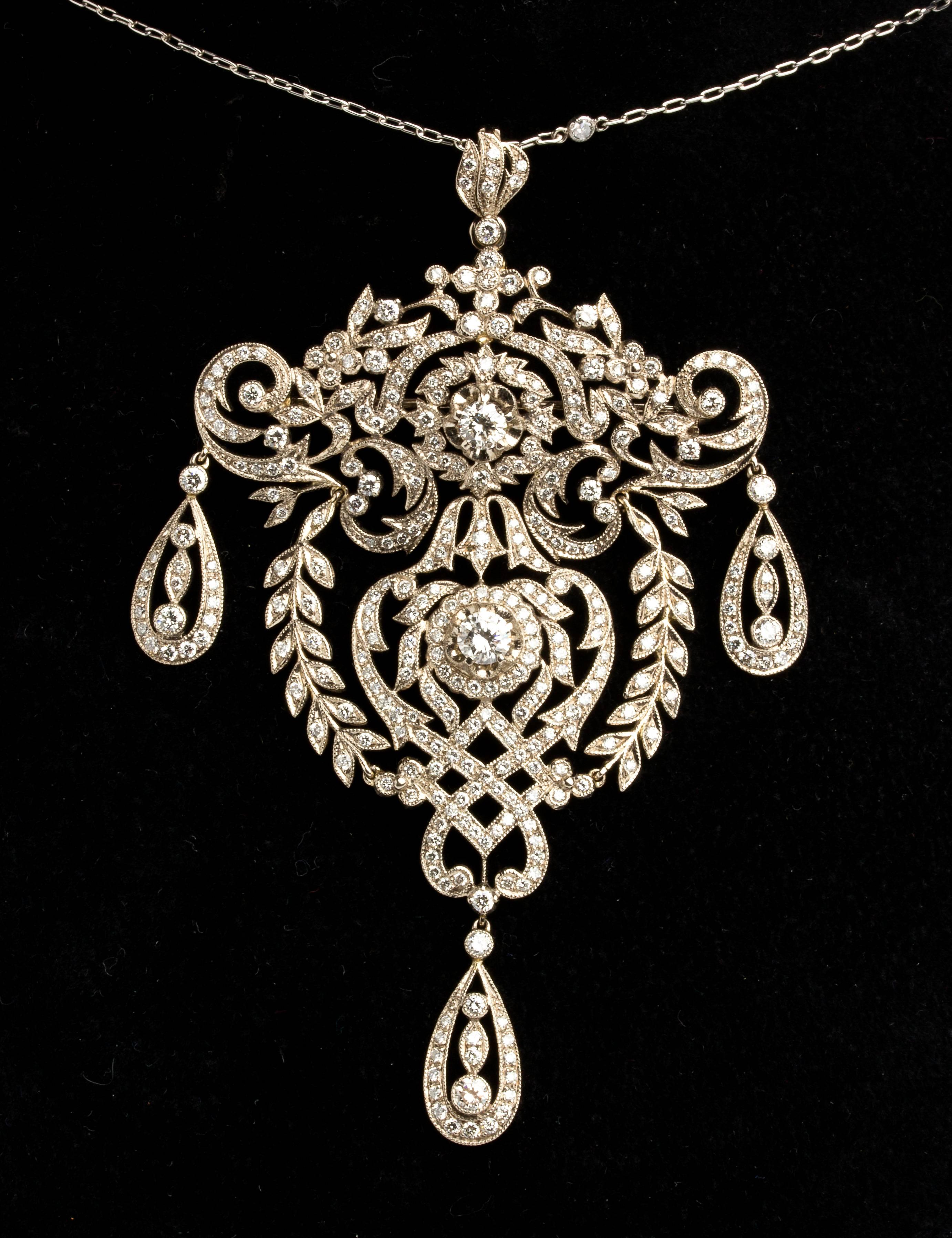 Comprising: a necklace and a pair of earrings finely made with floreal motif embellished with diamonds, H/I color, SI clarity, weighing total 7.40 ct. Total lenght 445 mm (17 33⁄64), pendant lenght 80 mm (3 5⁄32 in), pendant width 50 mm (1 31⁄32