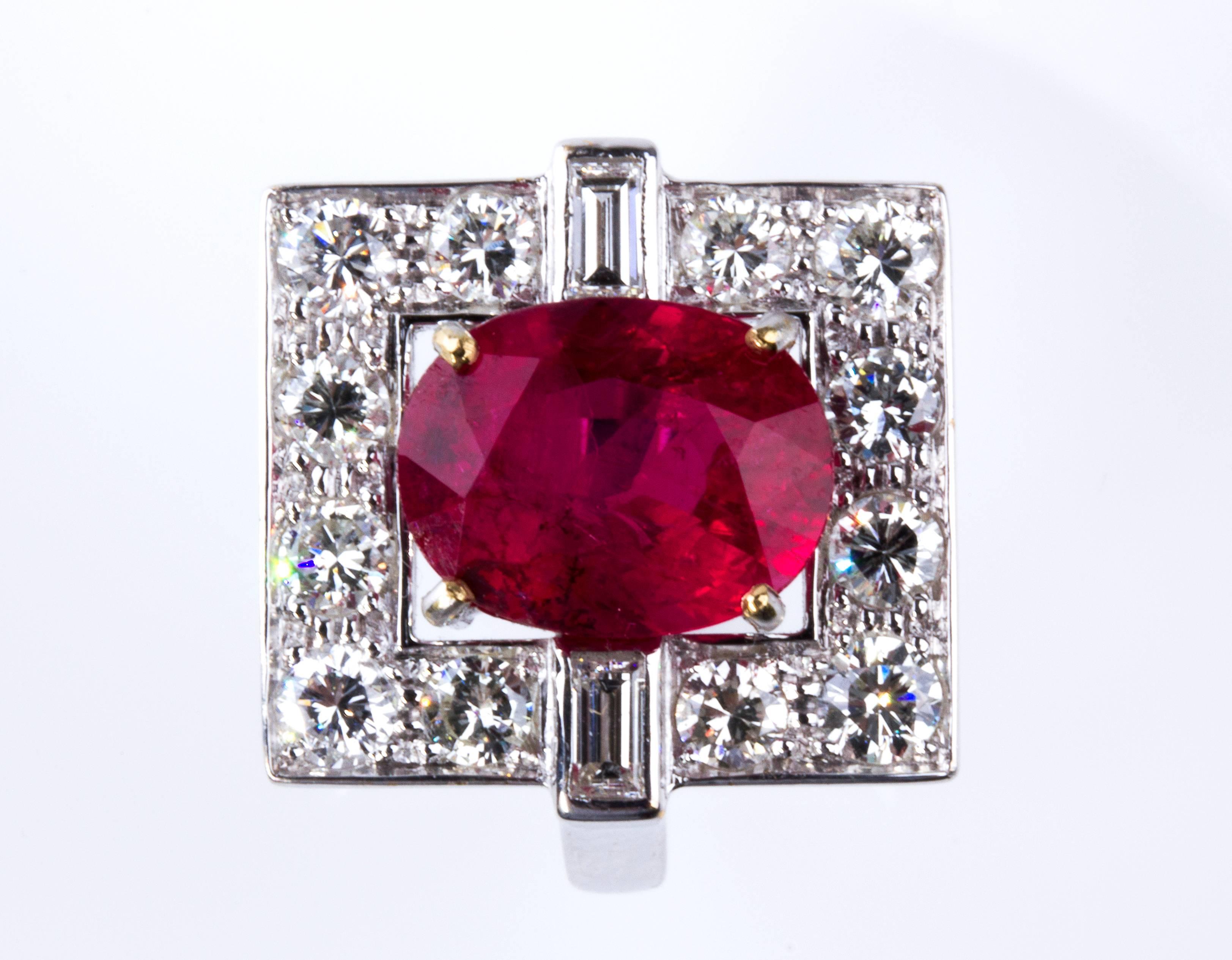 Realized in white gold designed with geometric motif, set cushion shaped ruby weighing 4.90 ct; surrounded by twelve brilliant cut diamonds, VVS clarity, F/G color, weighing 1.20 ct and two rectangular shaped diamonds, VVS clarity, F/G color,