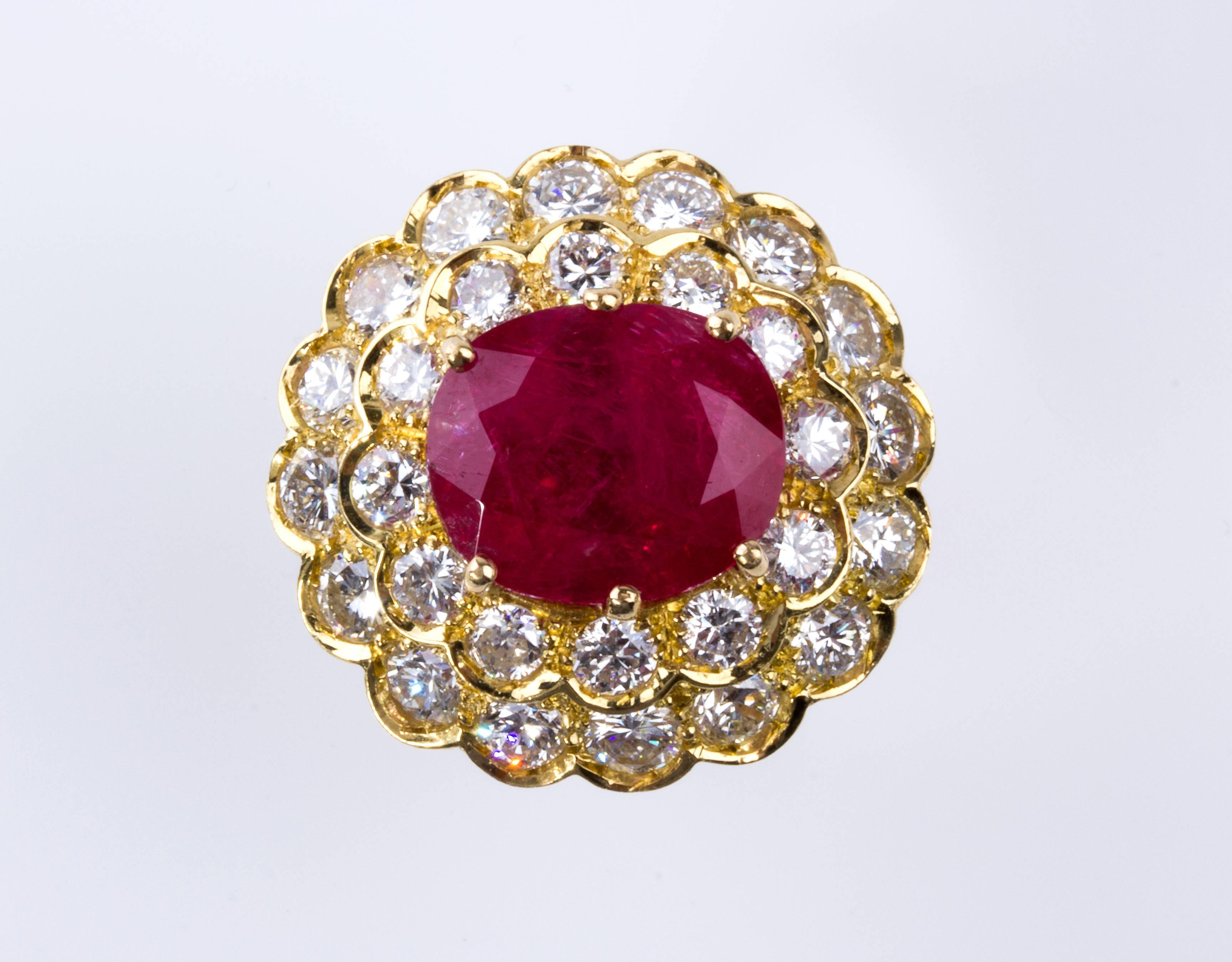 Realized in gold designed as a flower, set brilliant step, cushion shaped ruby, pinkish-red color, weighing 9.07 ct; surrounded by 28 brilliant cut diamonds, VVS clarity, G/H color weighing approximately 3.50 ct. Size US 7 1/2. Weight 13.6 gr.
