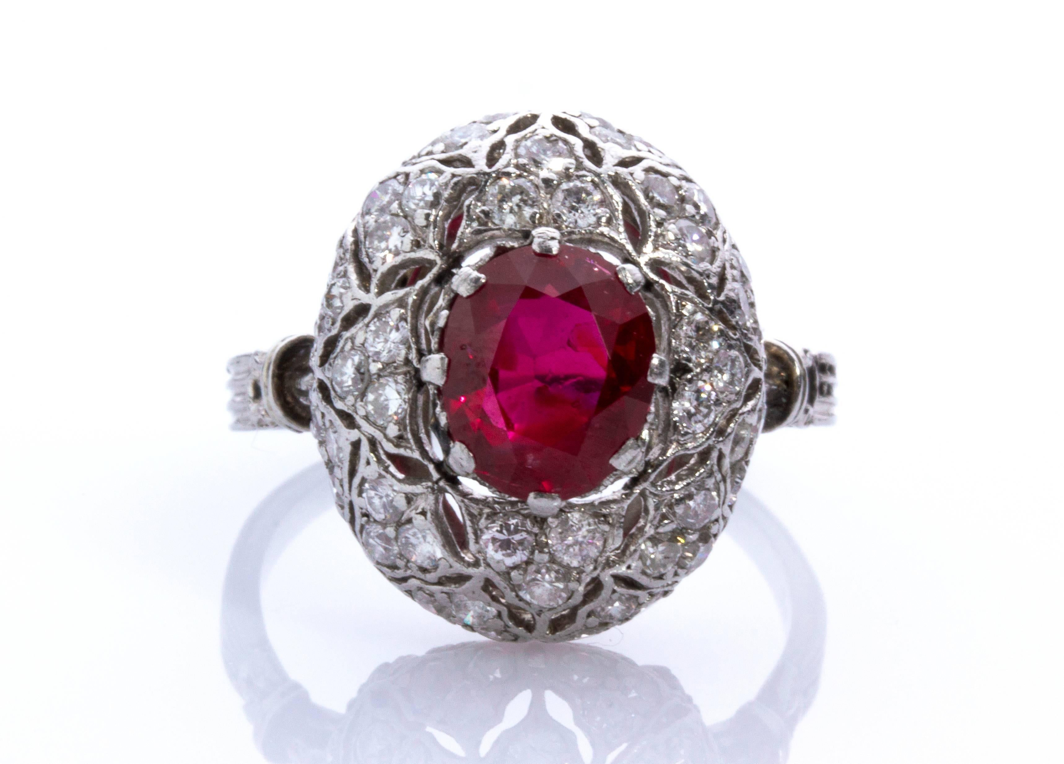 It features a rich red ruby weighing approx. 1.60 ct and high grade round brilliant cut diamonds, approx. 1.00 ct. The ring has the hallmarks of Mario Buccellati (M. Buccelalti  - b.1891, d.1965), an unusual ring made in platinum, in style of