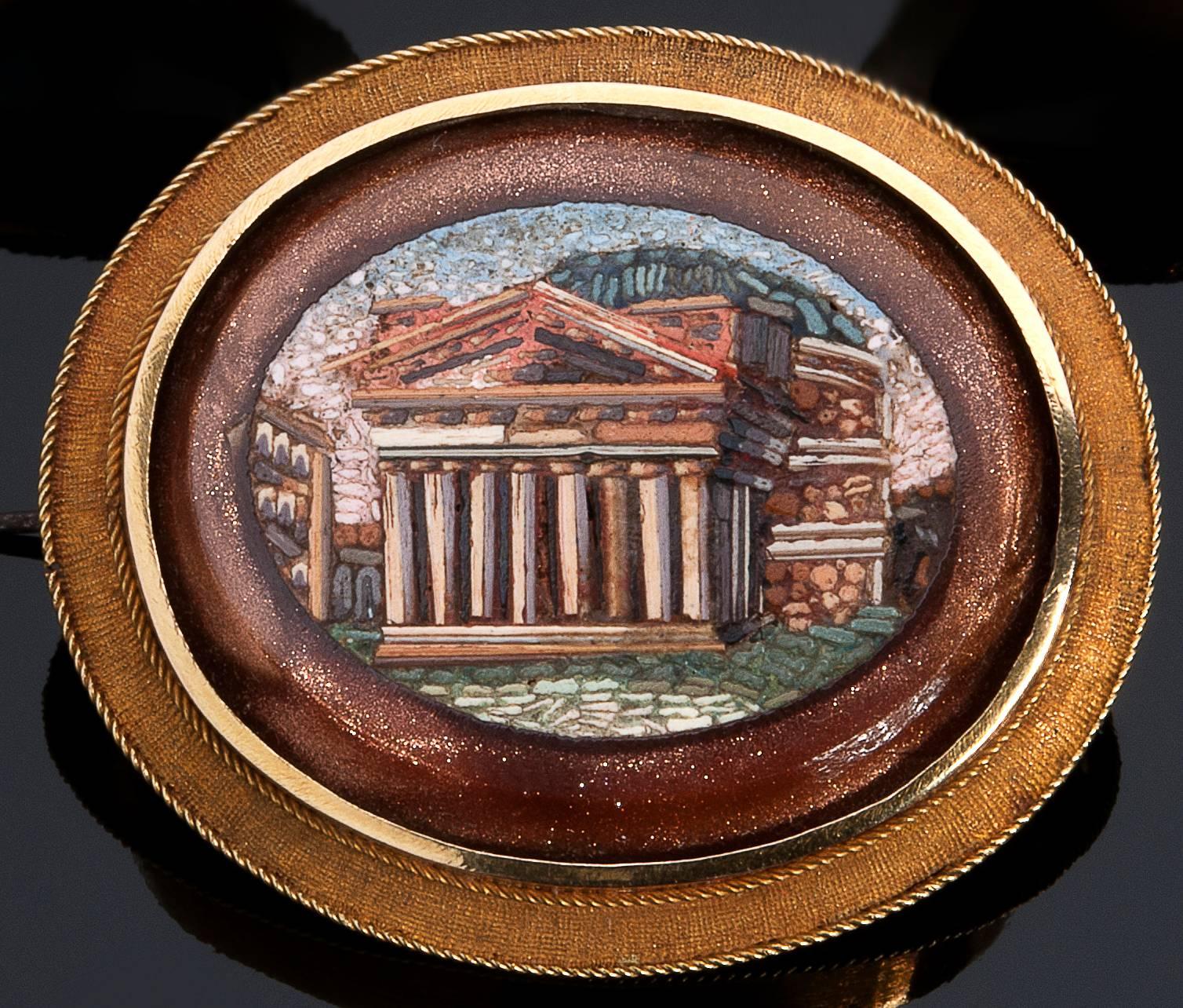 Set with three oval antique micromosaics depicting the Pantheon, the Temple of Saturn and arch of Septimius Severus. The gold frames are decorated in neoclassical style and the micromosaics are set into gold stone plaques. Brooch face 32 x 38 mm.