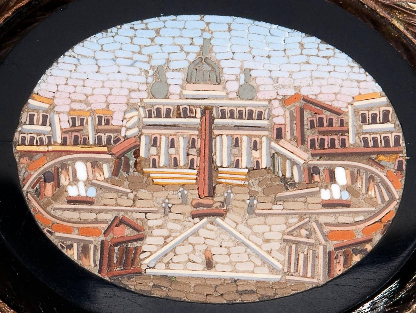 Micro-mosaic depicting St. Peter's Square set into a back glass plaque. Later gold mounting with Italian assay mark 750. Brooch face 38.4 x 44.6 mm. Weight 32.7 gr. Small tesserae of glass.  
Item condition grading: **** good - Ce.S.Ar.