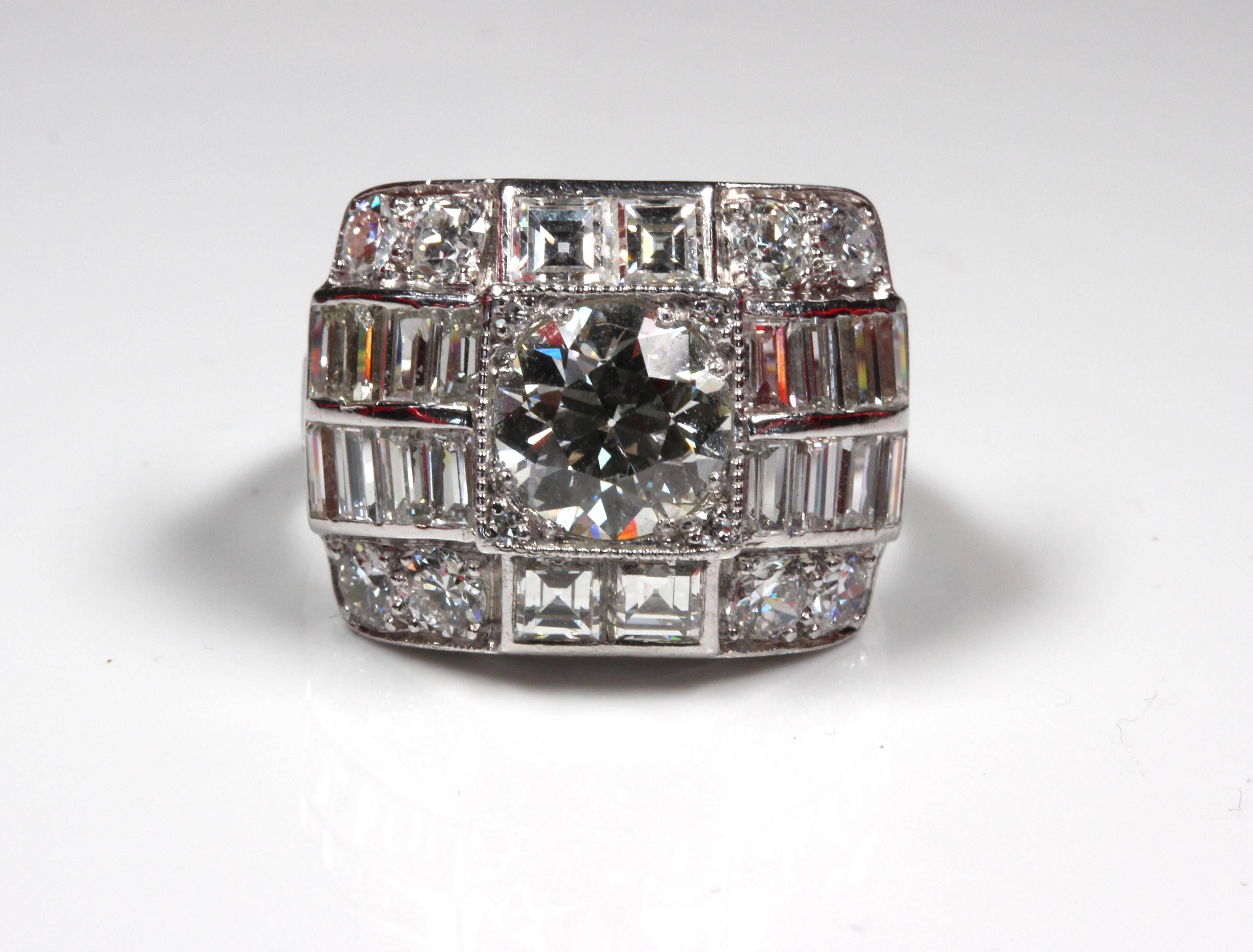 Magnificent Art Deco Diamond Ring, centre diamond estimated 1.78 carat, cut early modern brilliant, L, VS2, grain set, surrounded by asscher, baguette and early modern brilliant cut diamonds bringing total to 5.82 carat, domed design, filigree