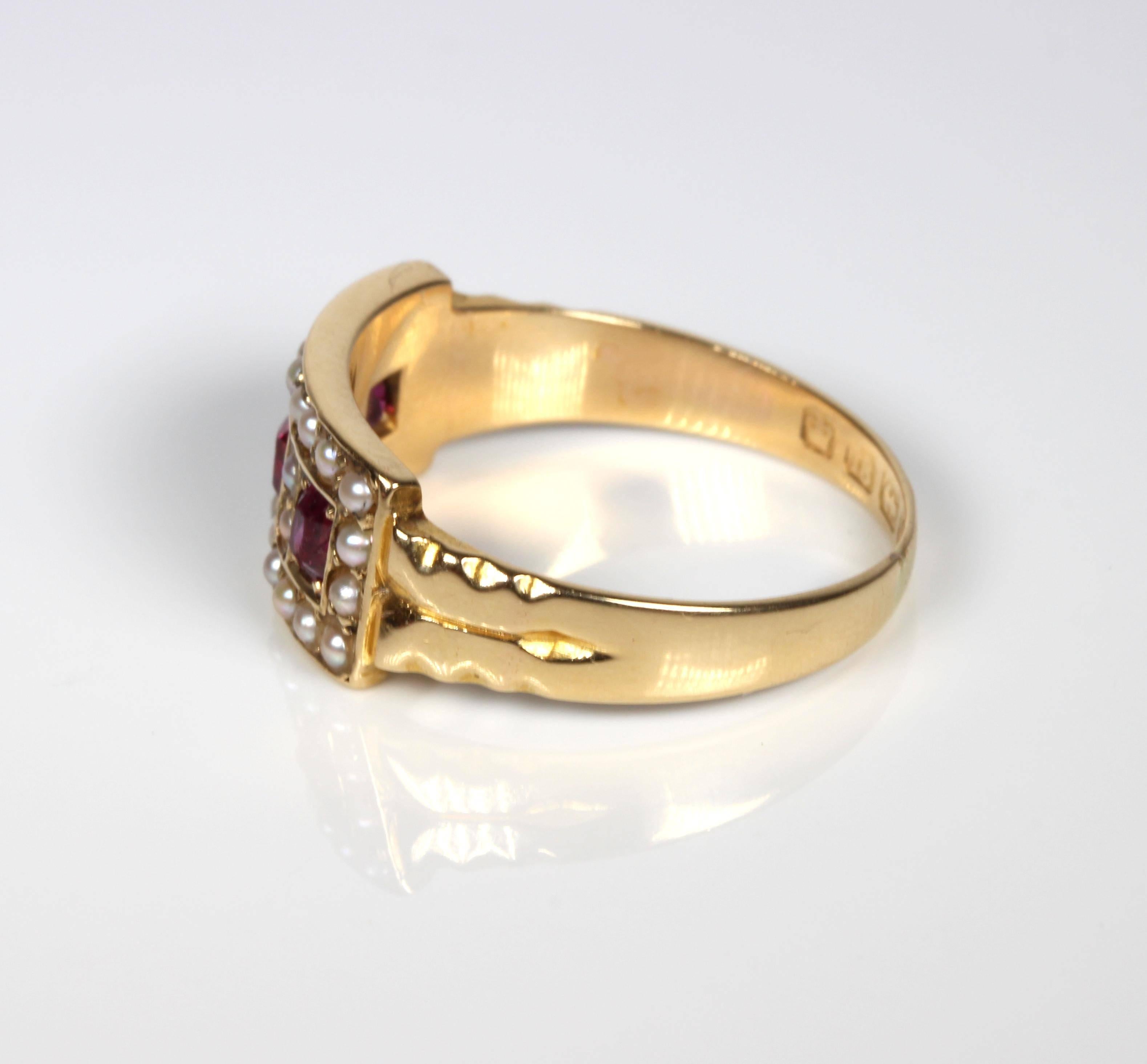 Stylish ruby and seed pearl dress ring set in 18ct gold with 3 oval facetted rubies and 26 seed pearls. Hallmarked for Birmingham 1893. Currently size N 1/2 (US=7) and can be safely sized by our expert jewellers. 18ct gold, English, Birmingham 1893.