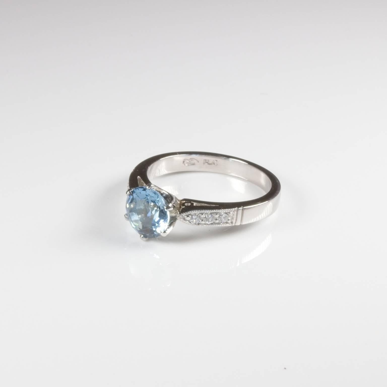 Gorgeous platinum aquamarine solitaire ring set with a moderate blue round aqua of 1.00ct and 6 shoulder diamonds of 0.08ct G/SI. Very stylish! Get that Markle Sparkle!