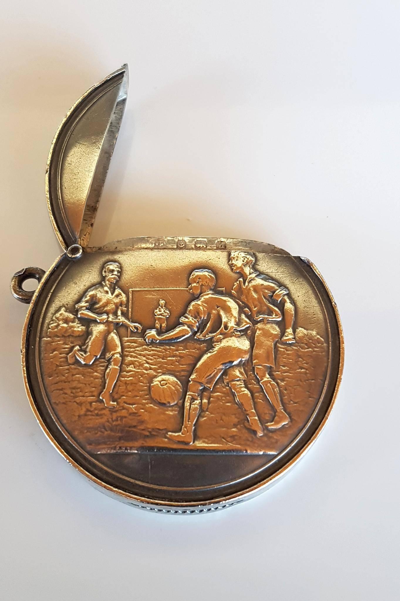Rare sterling silver novelty vesta case with striker used for wax matches in the shape of a football with Edwardian football players carved in relief. Hallmarked for Birmingham 1907, Maker JH. Love the Edwardian fashion evident in the outfits and