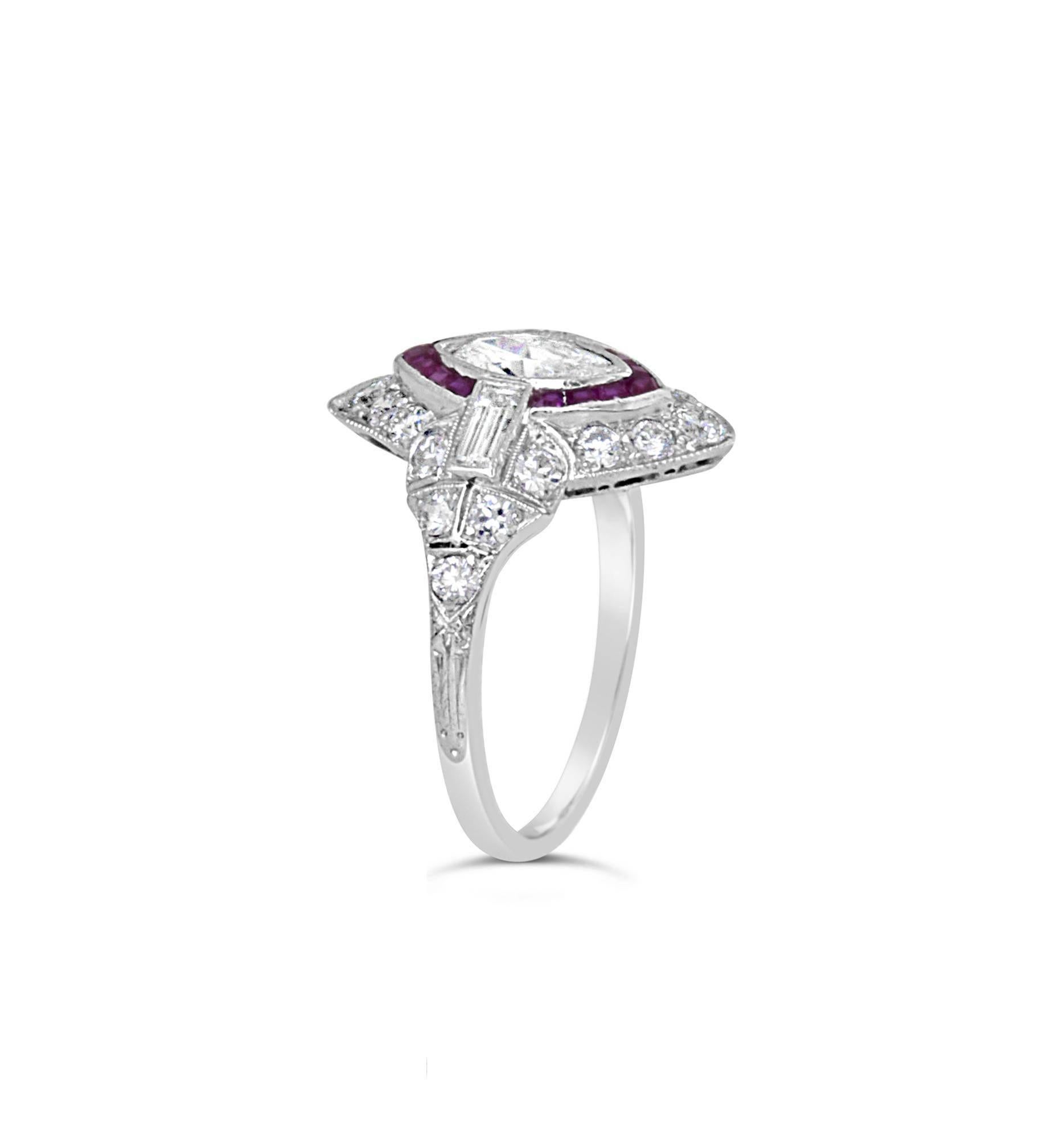 Gorgeous art deco platinum ring featuring an oval cut diamond of 0.42ct G VS1 surrounded by 14 French cut rubies, 2 baguette cut diamonds of 0.24ct each G VS, 14 round brilliant cut diamonds forming the marquise shape of approx 0.48ct G VS and 6