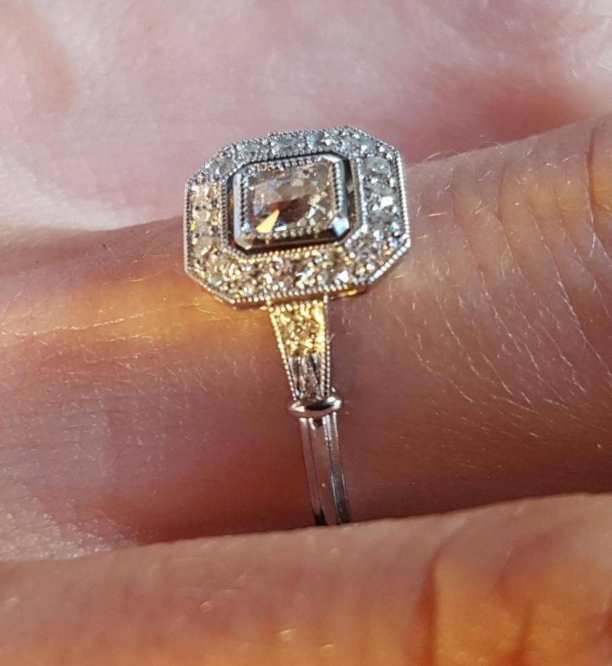 Sleek and stylish engagement ring made by our master jeweller in platinum. Featuring an old mine cut diamond of 0.25ct in an illusion setting surrounded by 16 single cut diamonds of 0.01ct F/VS in an octagonal top plate with one diamond of 0.01ct in
