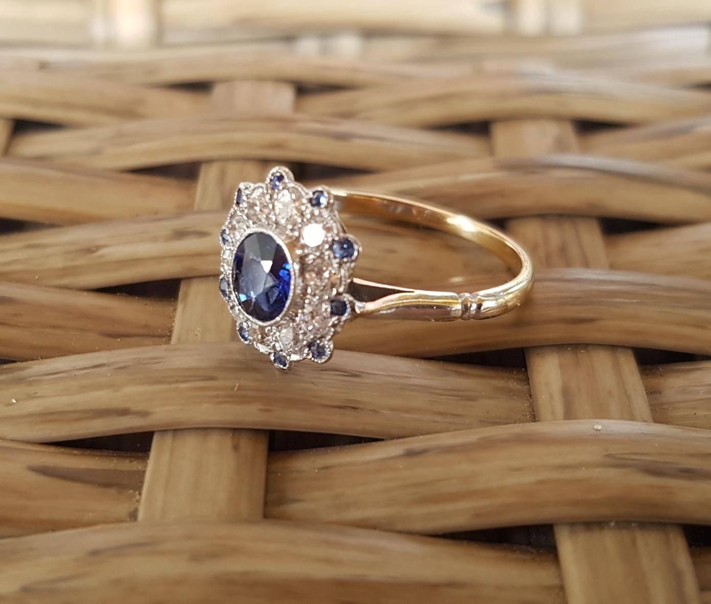 Very pretty 18ct white gold art deco sapphire and diamond cluster ring set with a centre deep blue oval facetted Ceylon sapphire surrounded by 10 old cut diamonds(early modern brilliant cut) 10=0.37ct H/VS and 10 small round sapphires. Currently