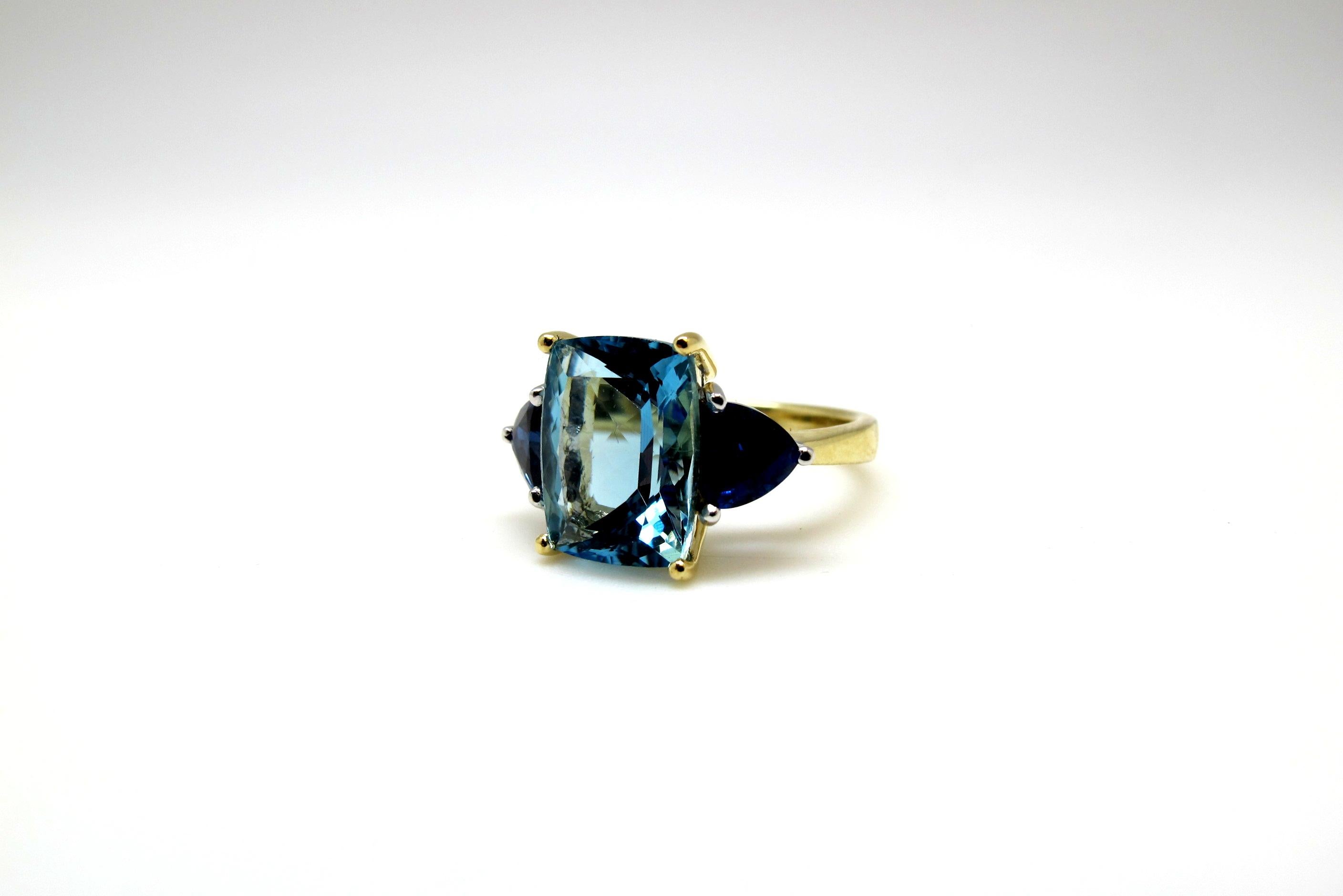 This ring is an exquisite combination of color, size and design. We have combined gem quality, richly colored aquamarine and velvety, royal blue sapphires to create a beautiful color pairing of blue on blue. The gemstones are of superior color,