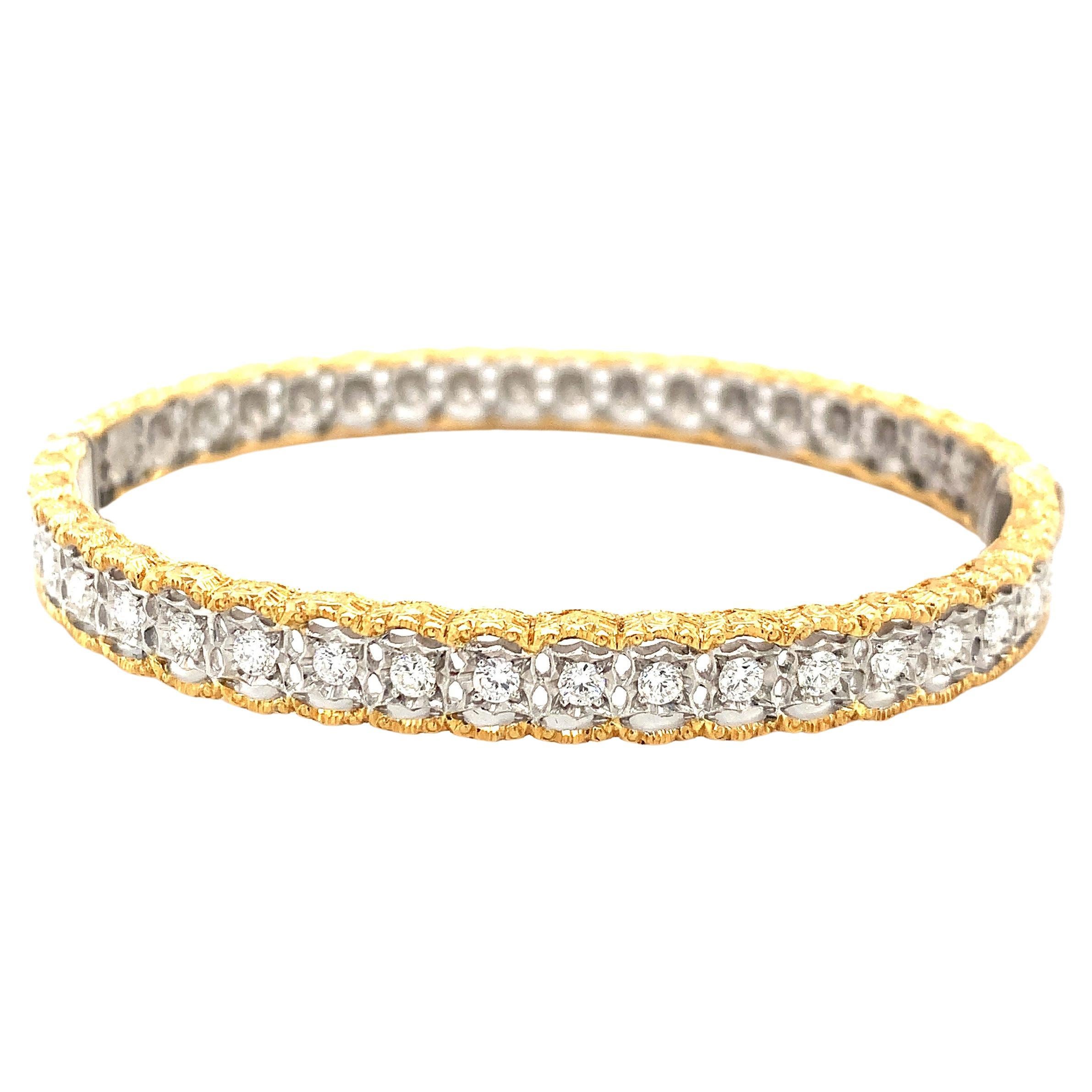 This stunning Florentine style, yellow and white gold bangle bracelet was handcrafted in Italy and is set with a carat of diamonds. The center of the bangle is 18k white gold that has been intricately pierced into individual settings that showcase