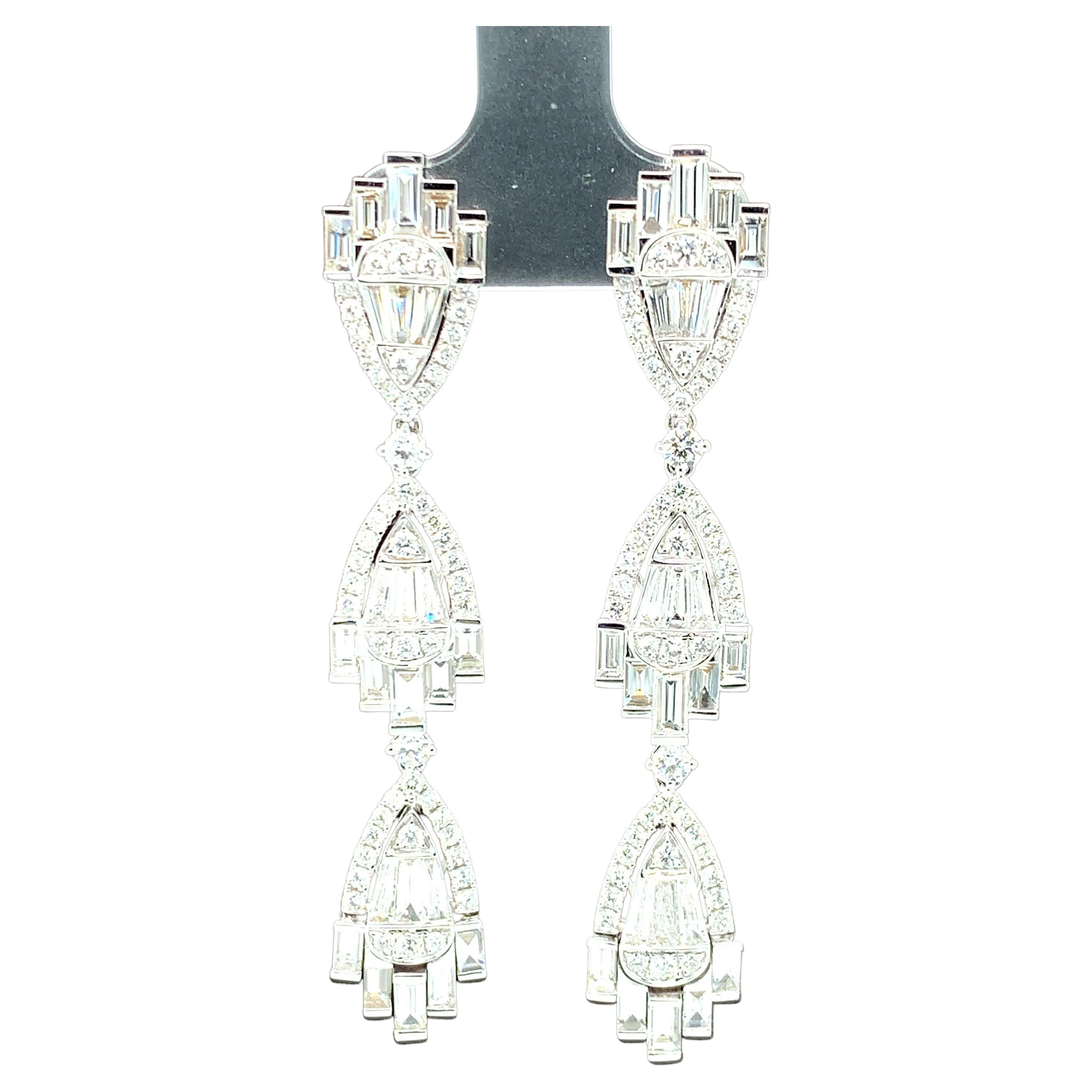 These Art Deco-inspired dangle earrings are simply spectacular! They are just in time for the holidays and perfect for every special occasion imaginable! Over 5 and a half carats of top quality diamonds are masterfully arranged in an elegant,