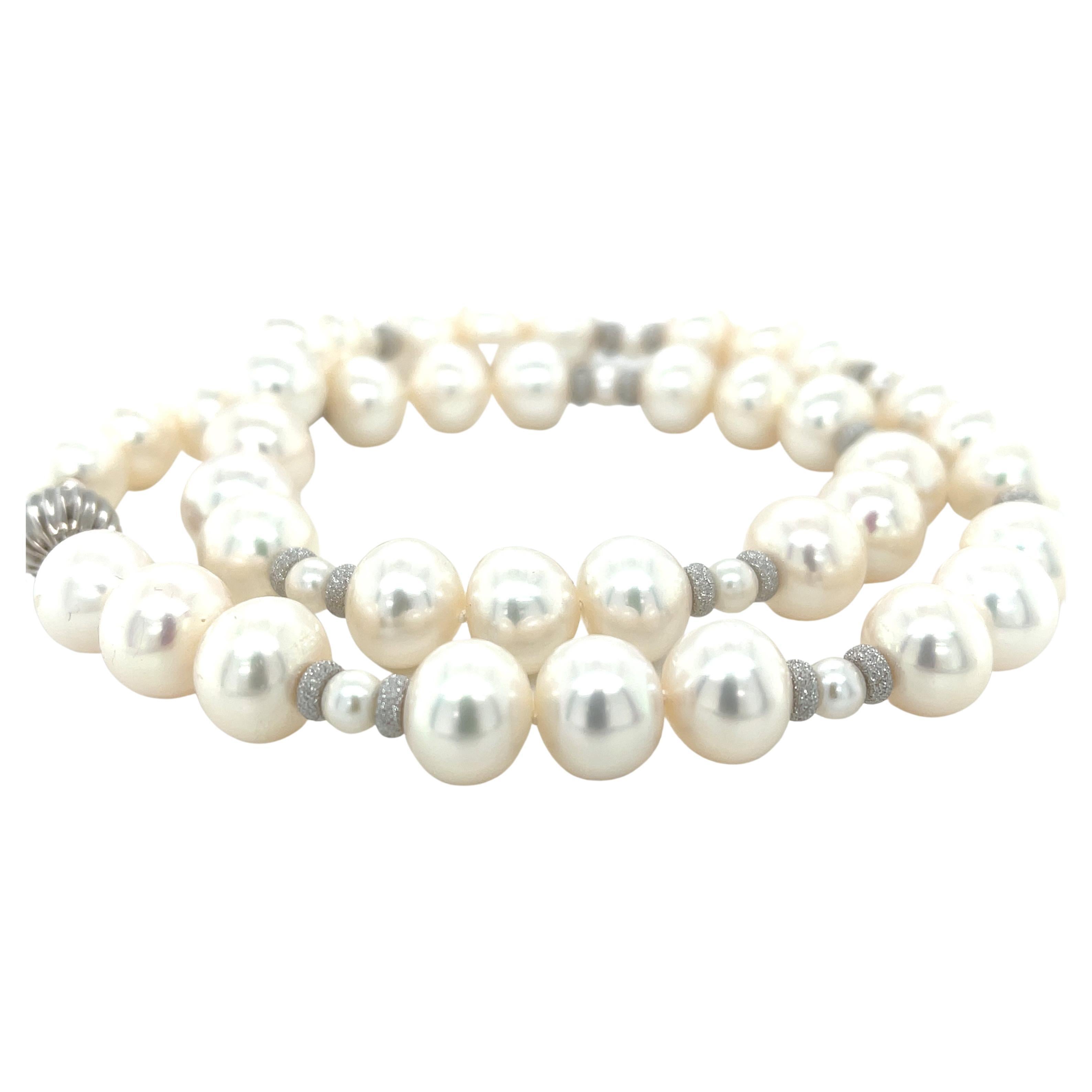 This contemporary strand of gorgeous white freshwater pearls is an updated version of a timeless classic! These pearls have beautiful luster, with subtle pink and gray tones and a fun 