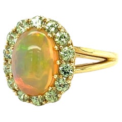 2.40 Carat Opal and Tsavorite Garnet Halo Cocktail Ring in 18k Yellow Gold