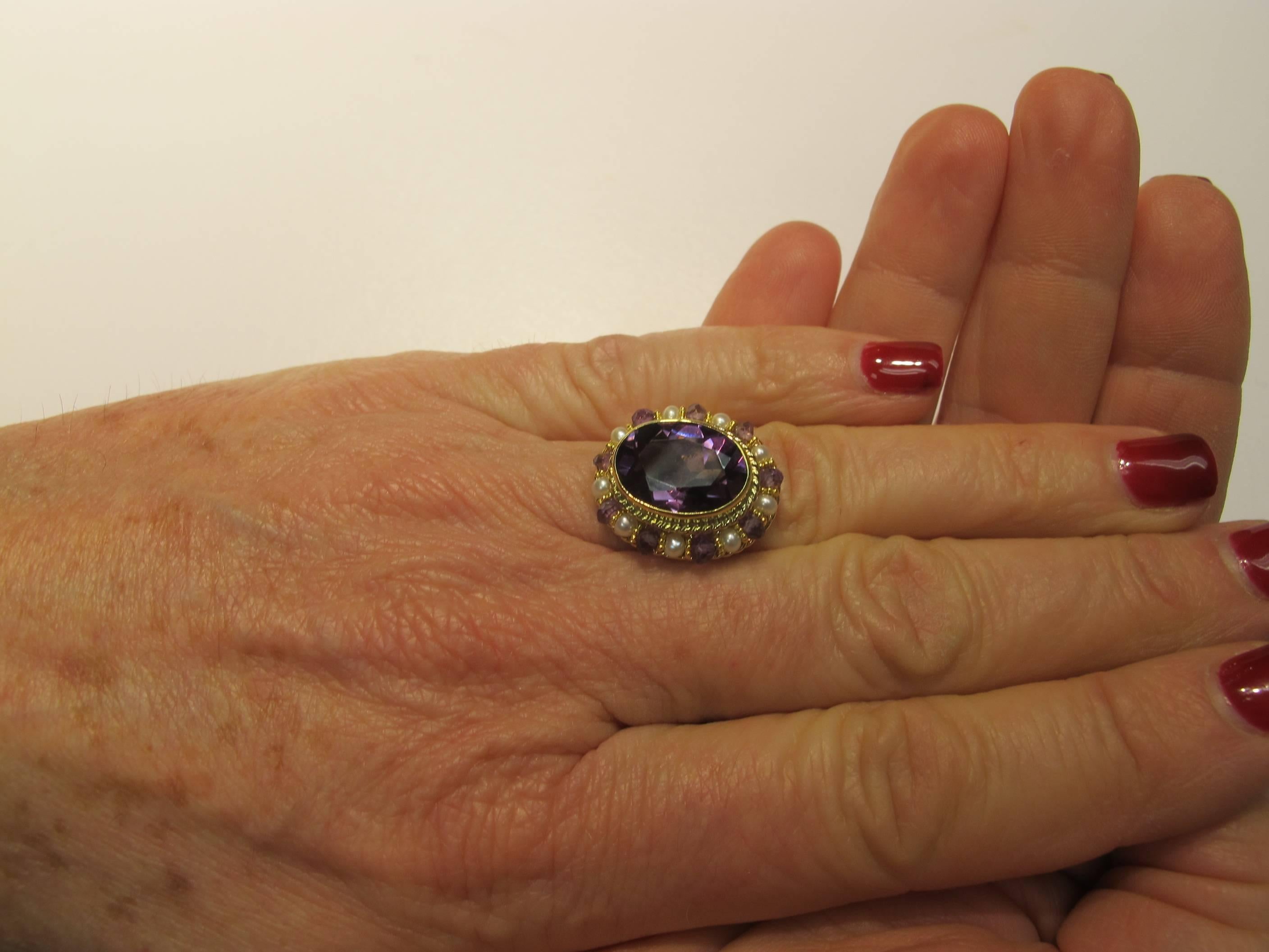 This ring features a lavender color, oval, facetted Amethyst (14.50x10.50, 9.90 carats) encircled by 2mm Seed Pearls and Amethyst beads strung on gold wire. This style of craftsmanship is seldom seen. 100% handmade filigree made from 18k gold wire.