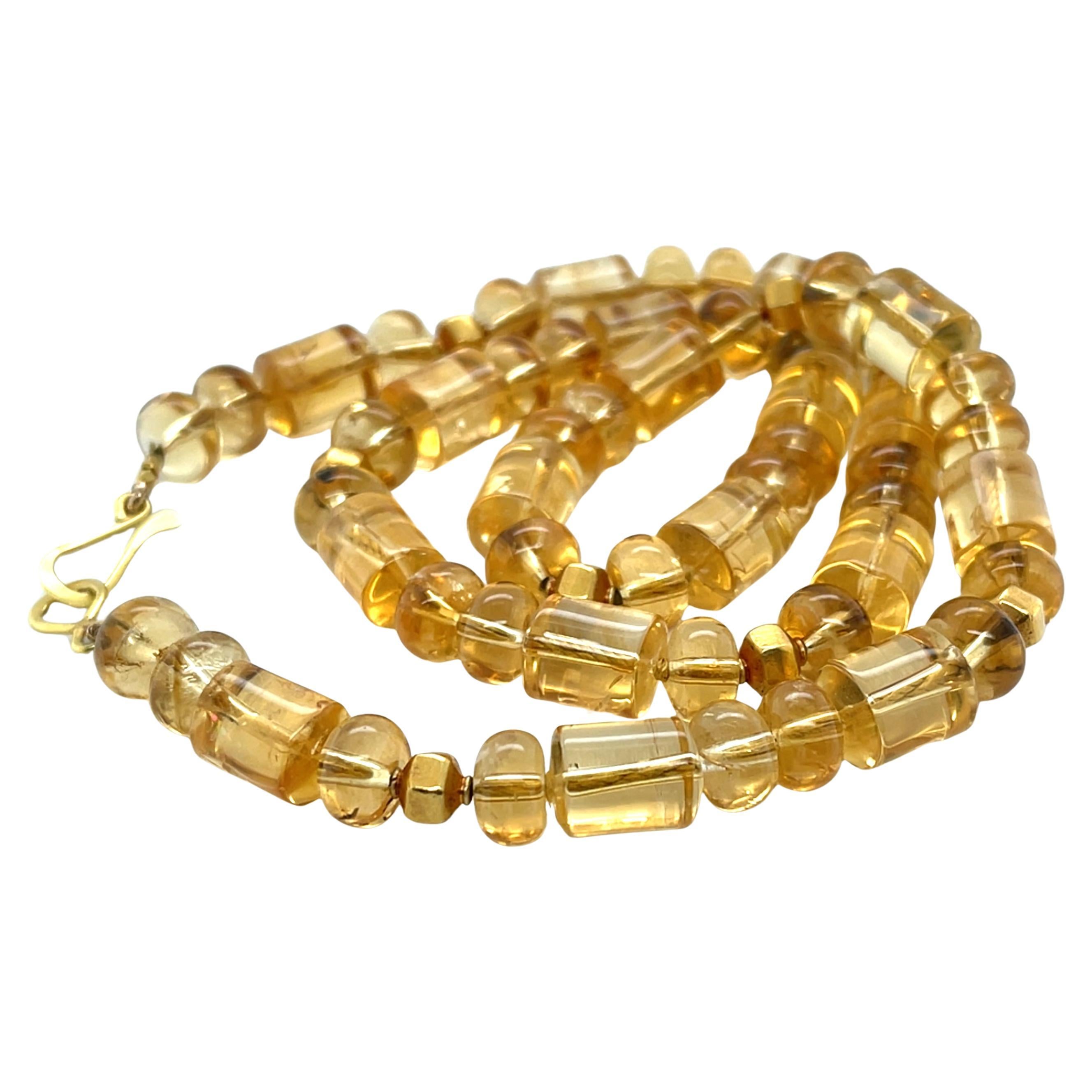 The warm glow of these beautiful citrine beads brings sunshine to everyday life! This golden strand of barrel-shaped and oval citrine beads has been carefully strung with 18k and 22k yellow gold accents, elevating this necklace to new heights.