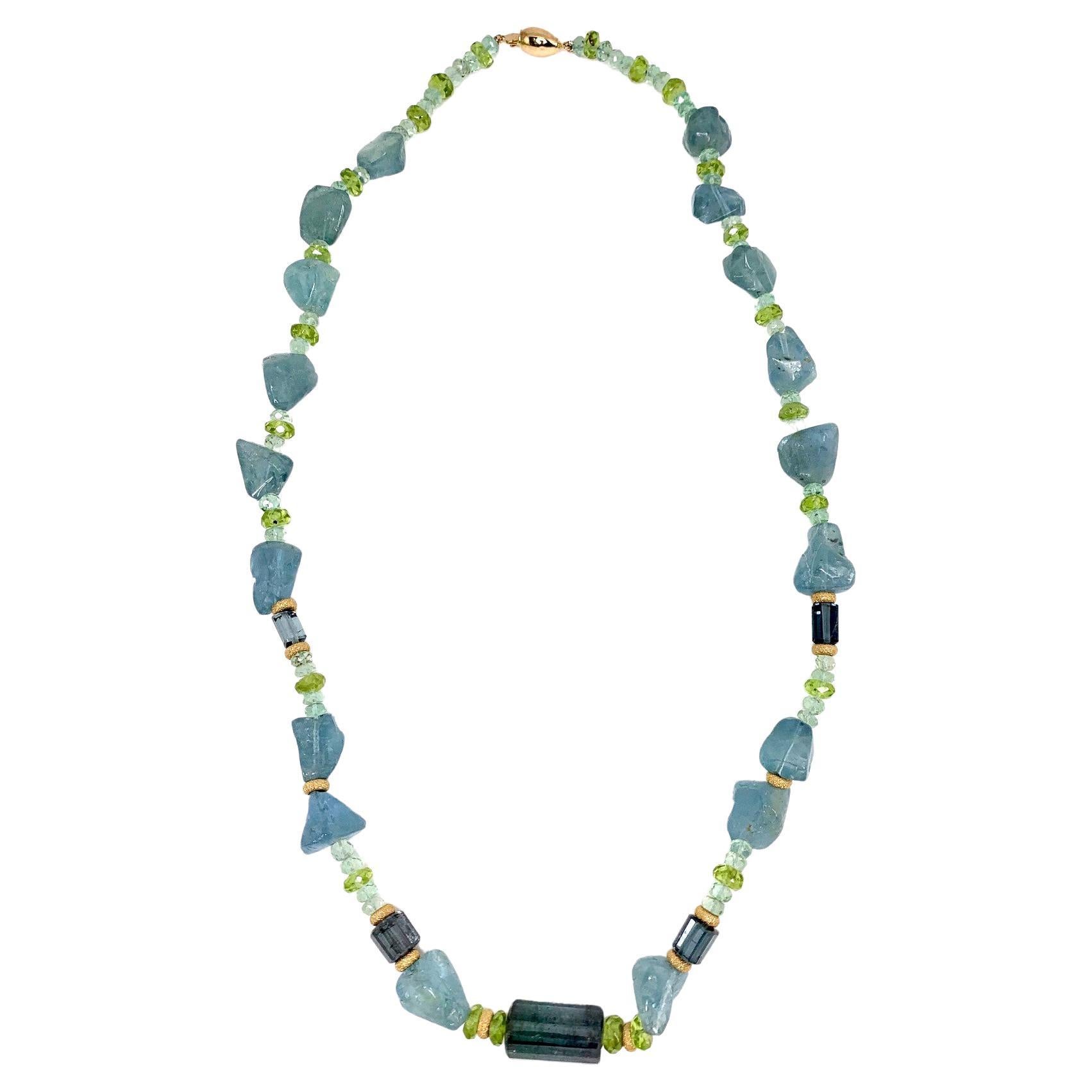 Sea water blue aquamarine, teal blue indicolite tourmaline and lime green peridot come together and blend beautifully in this necklace. This strand features aquamarine nuggets, faceted aquamarine beads, and elongated segments of indicolite