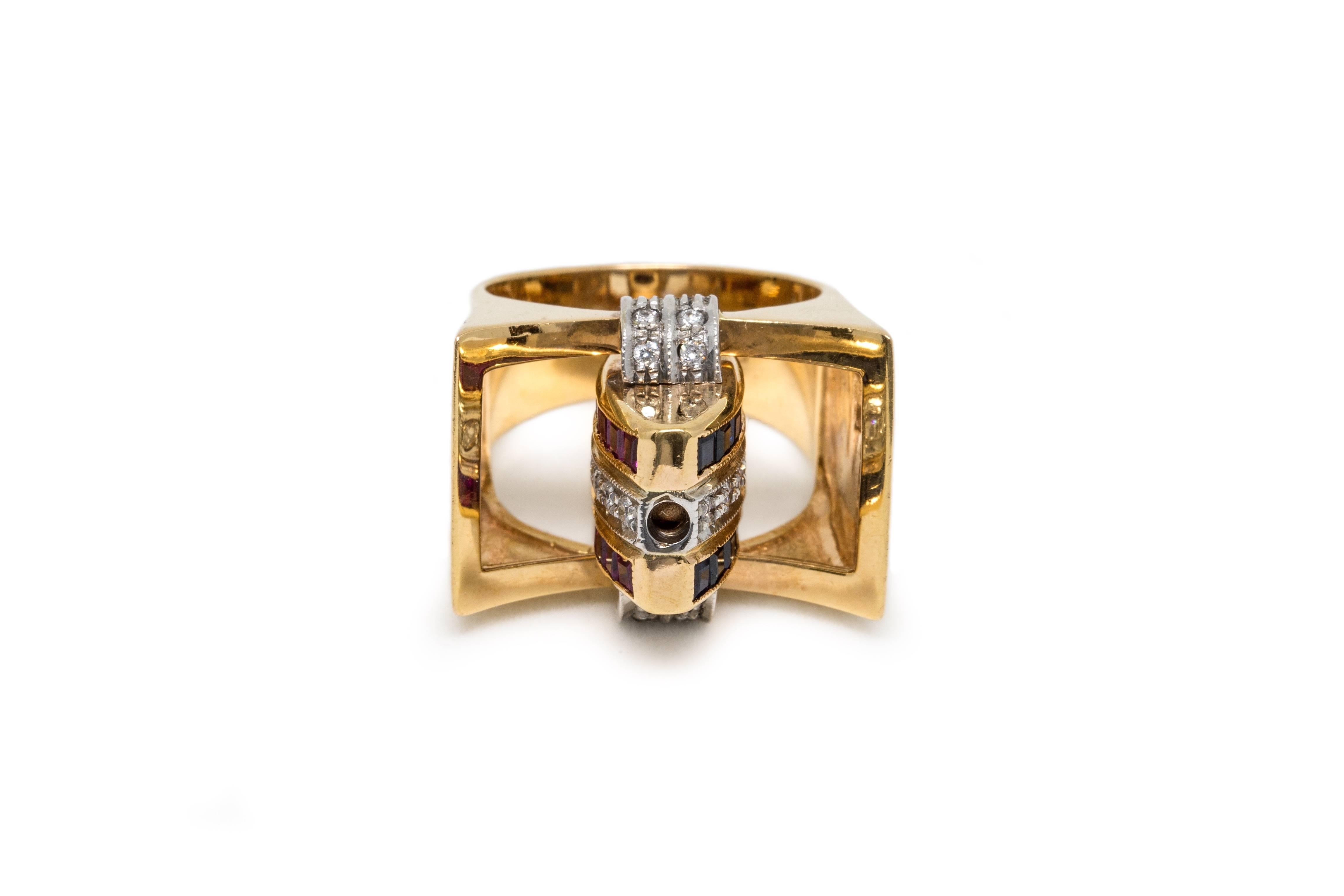 An unusual ruby, sapphire and diamond swivel ring set in 18K yellow gold. The middle section swivels so that you can have on show the sapphires or the rubies. 

The swivel section made with a line of diamonds framed by two bands of square cut