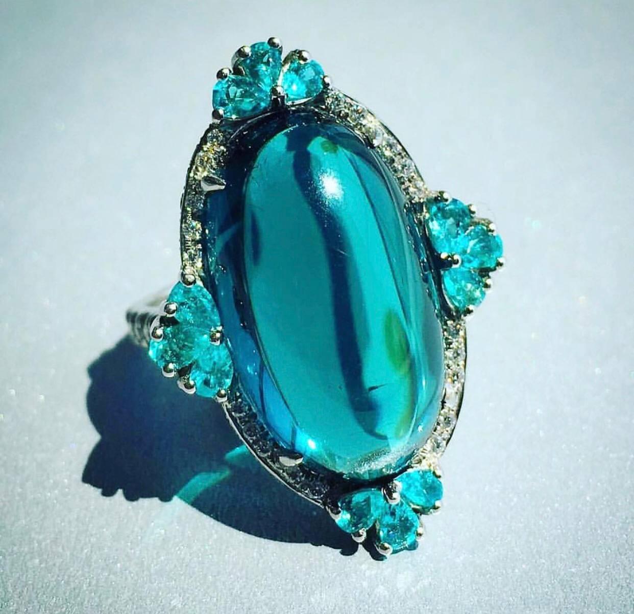 Blue Tourmaline, Indiculite in the Platinum setting is one of the best  gems available   Blue Color  Gem is   pure Teal and clean, which is rare for this type of stone. Accented with 12  Pear shape Brazilian Paraiba Tourmaline's, enhanced with