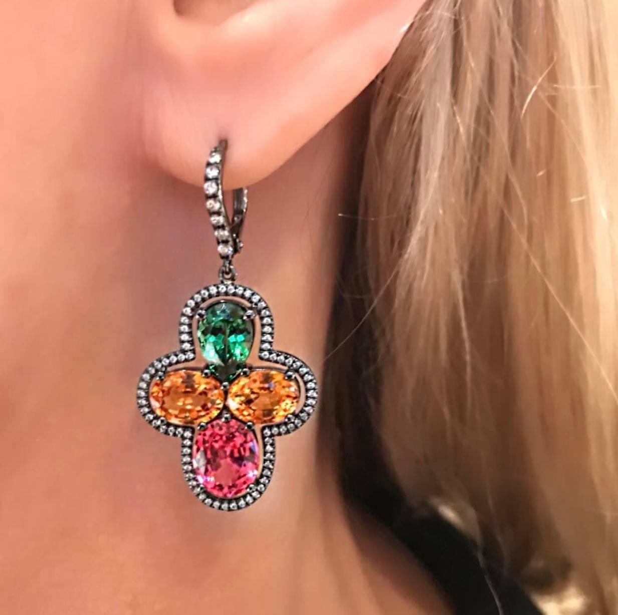 18 K white Gold Earrings, with Green Garnet, Orange  Garnet and Neon Pink Spinels, Surrounded with white Diamonds, Black Rhodium Plated.
The earrings have very dynamic color combination:  Neon Pink Spinel, Orange Garnet and Green Garnet, can be worn