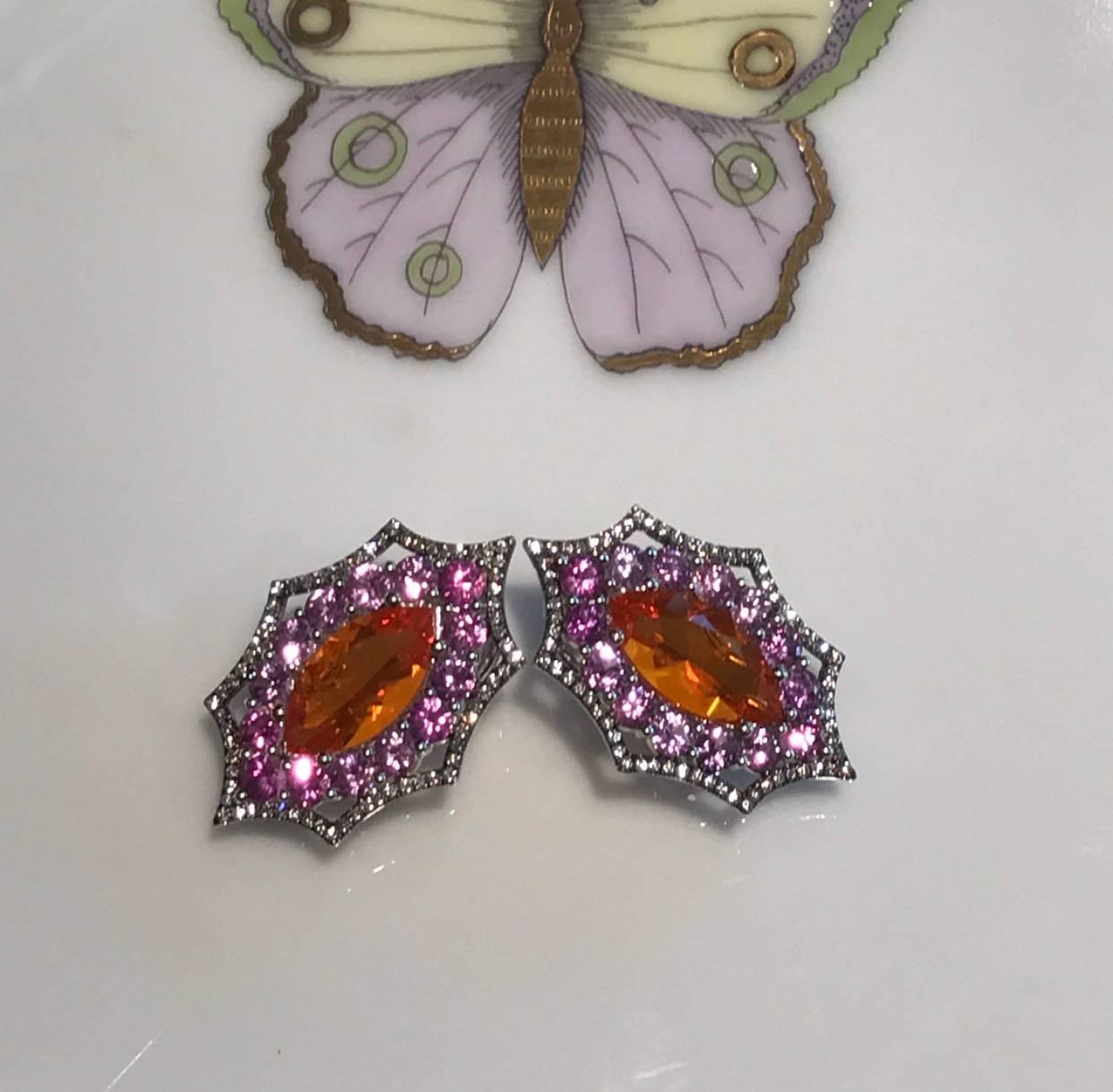18 K white Gold Earrings with Mexican Opal in Marque shape is Surrounded with Purple Sapphires and accented with white Diamonds, Black Rhodium Plated. Color combination of Orange and Purple in this earring is inspired by the feathers of exotic bird,
