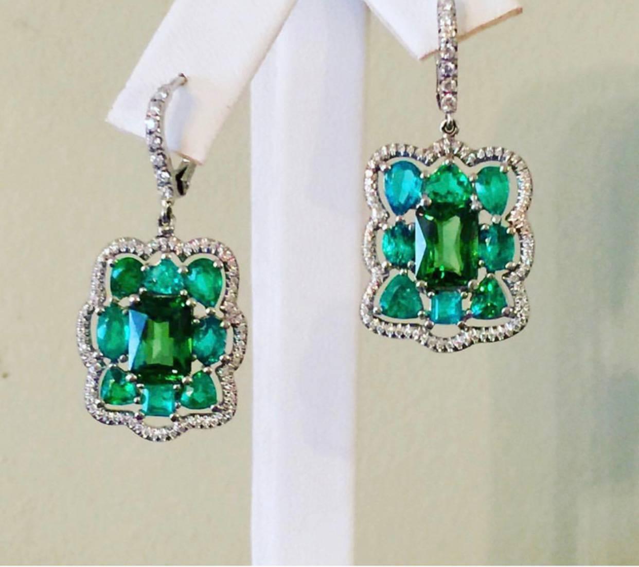 The Platinum Earrings are one of a kind modern heirlooms. GIA certified Tsavorites are the perfectly matched Highest Quality  Radiant Cut Stones, they are Surrounded by Brazilian Paraiba  Tourmaline's, each of these Paraibas are shimmering with Neon