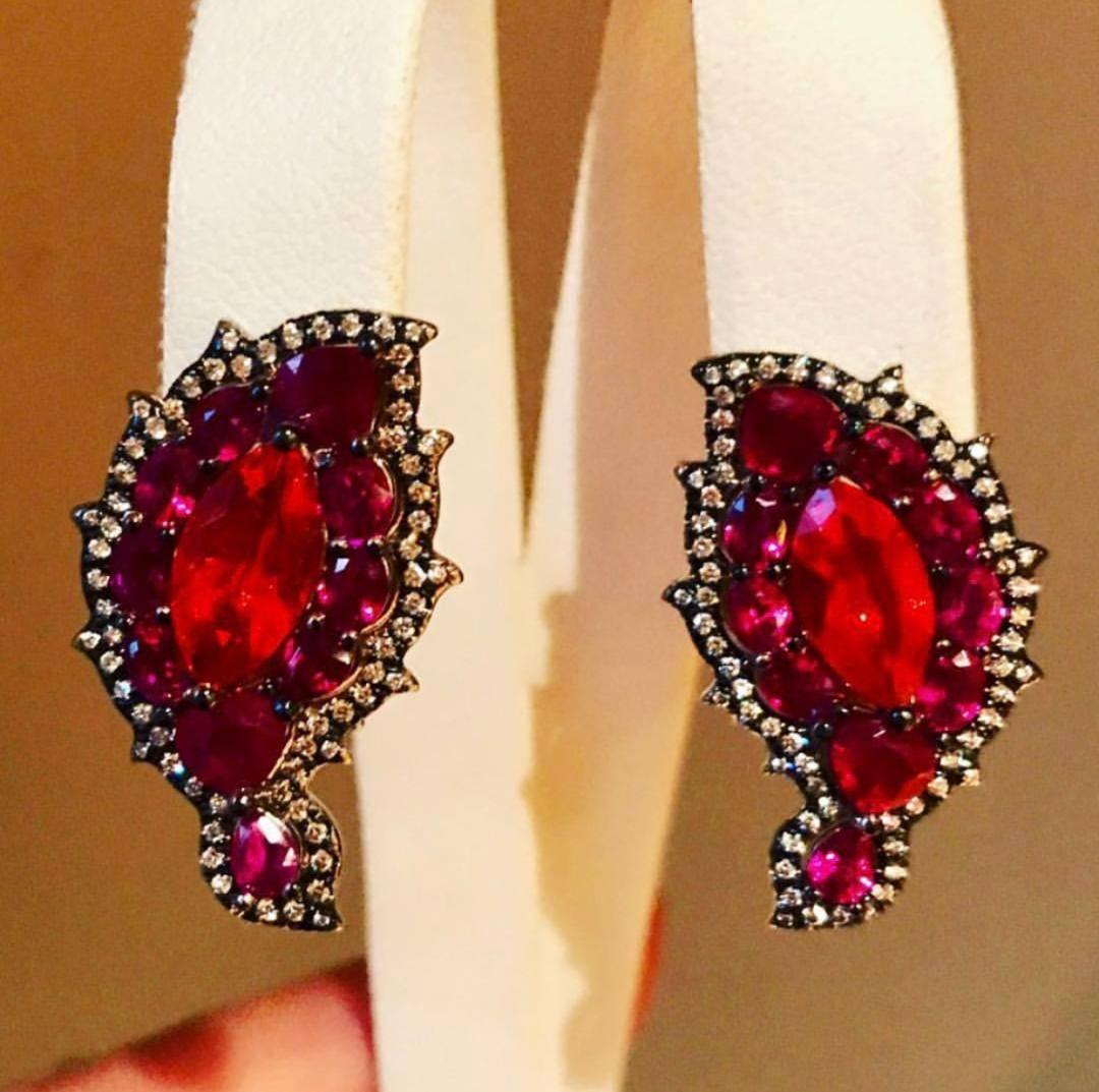 The 18 K white Gold Earrings: Phoenix Feathers ,Have Marquise shape Mexican Opal Center Surrounded With Various Shapes of Burmese Rubies, Accented with Colorless Diamonds, Clip/Post Back.
Mexican Opal 2.19 CT
20 Rubies 4.93 CT
130 Diamonds .56